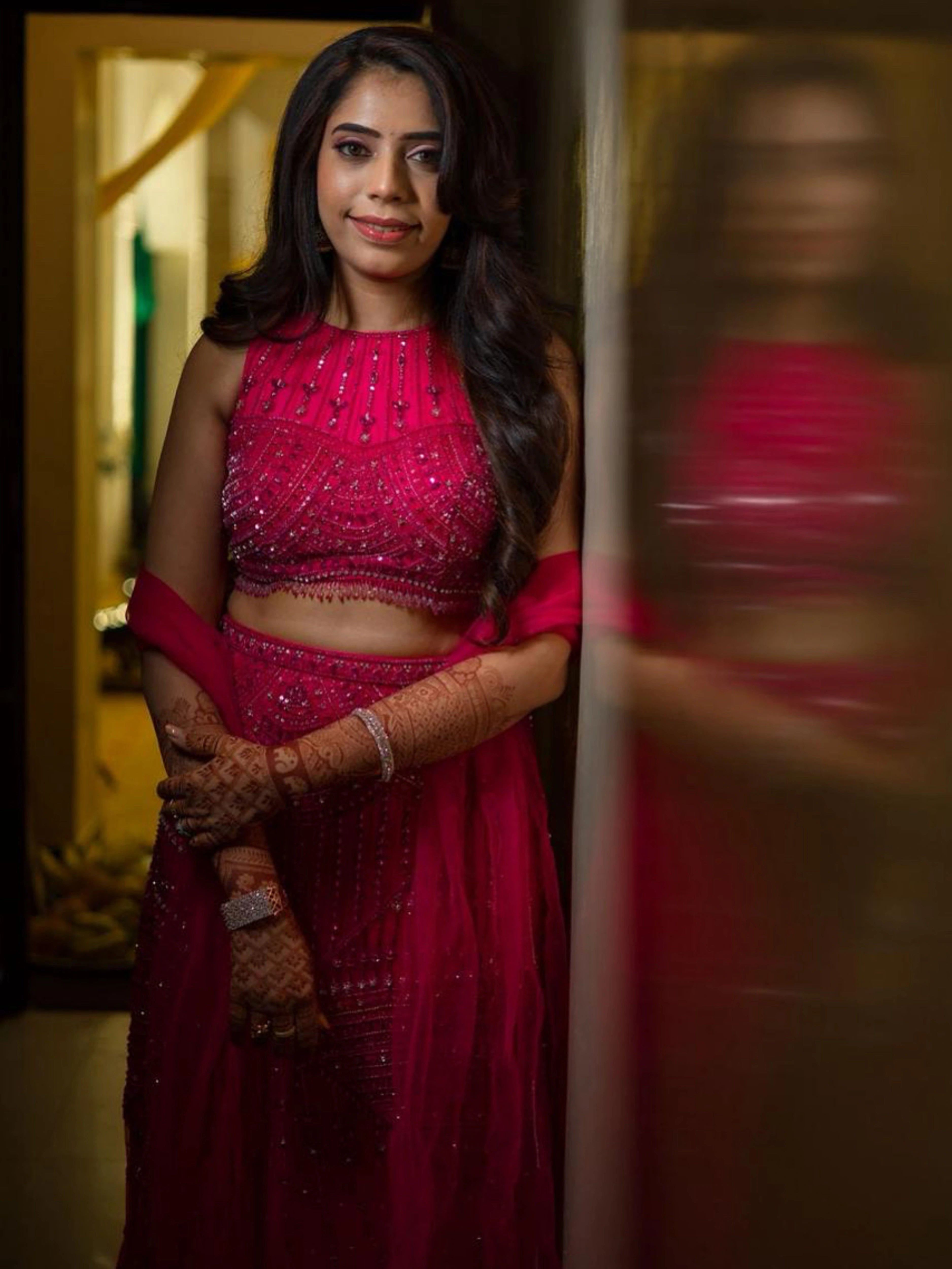 Bride in a pink tulle mermaid lehenga, intricately handcrafted by team Archana Karthick