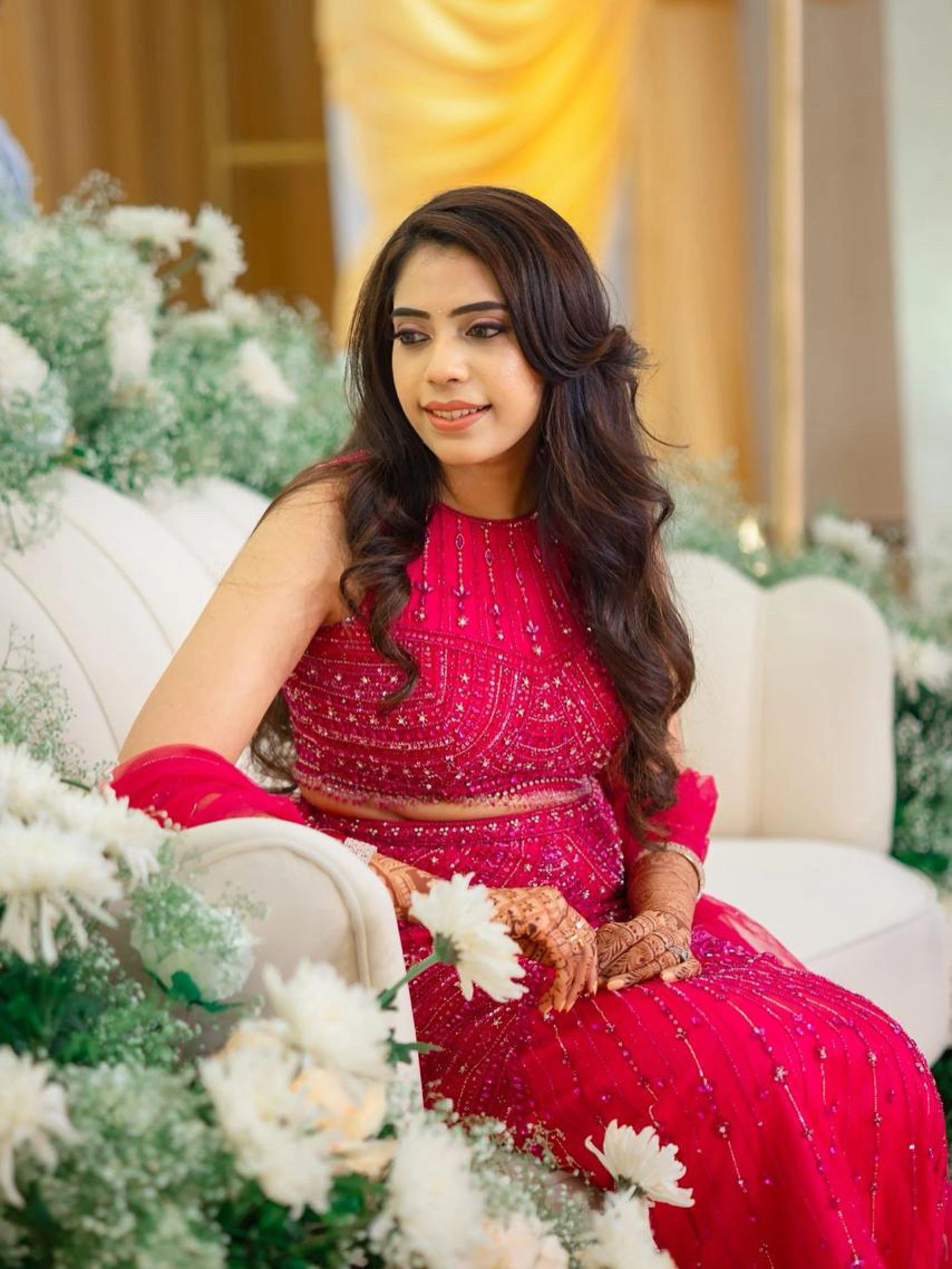 Bride on stage in a pink tulle mermaid lehenga, intricately handcrafted by team Archana Karthick