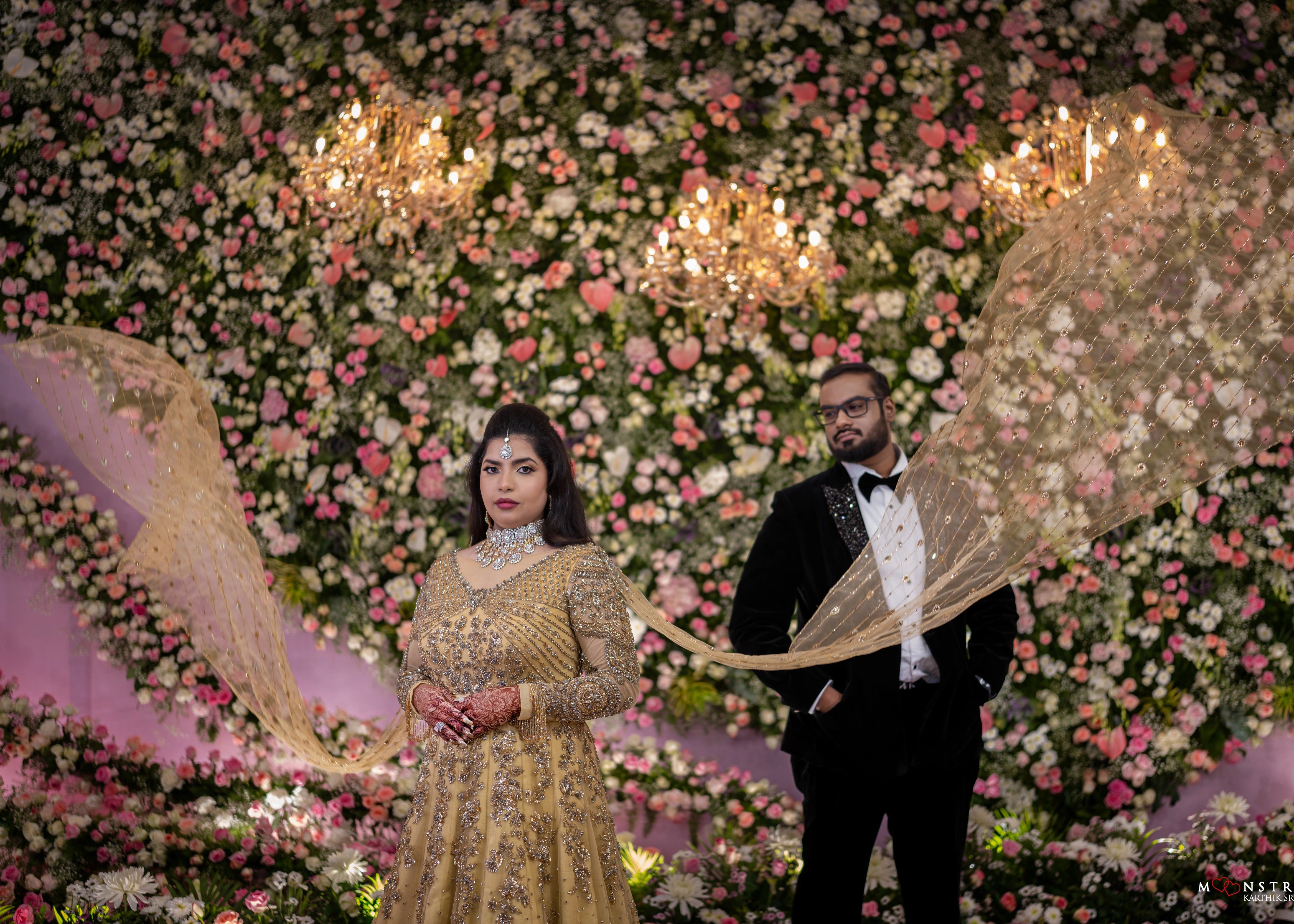 Bride's train in a gold gown in tulle designed by Archana Karthick and handcrafted with rhinestones and cut dana with floral and geometric motifs.