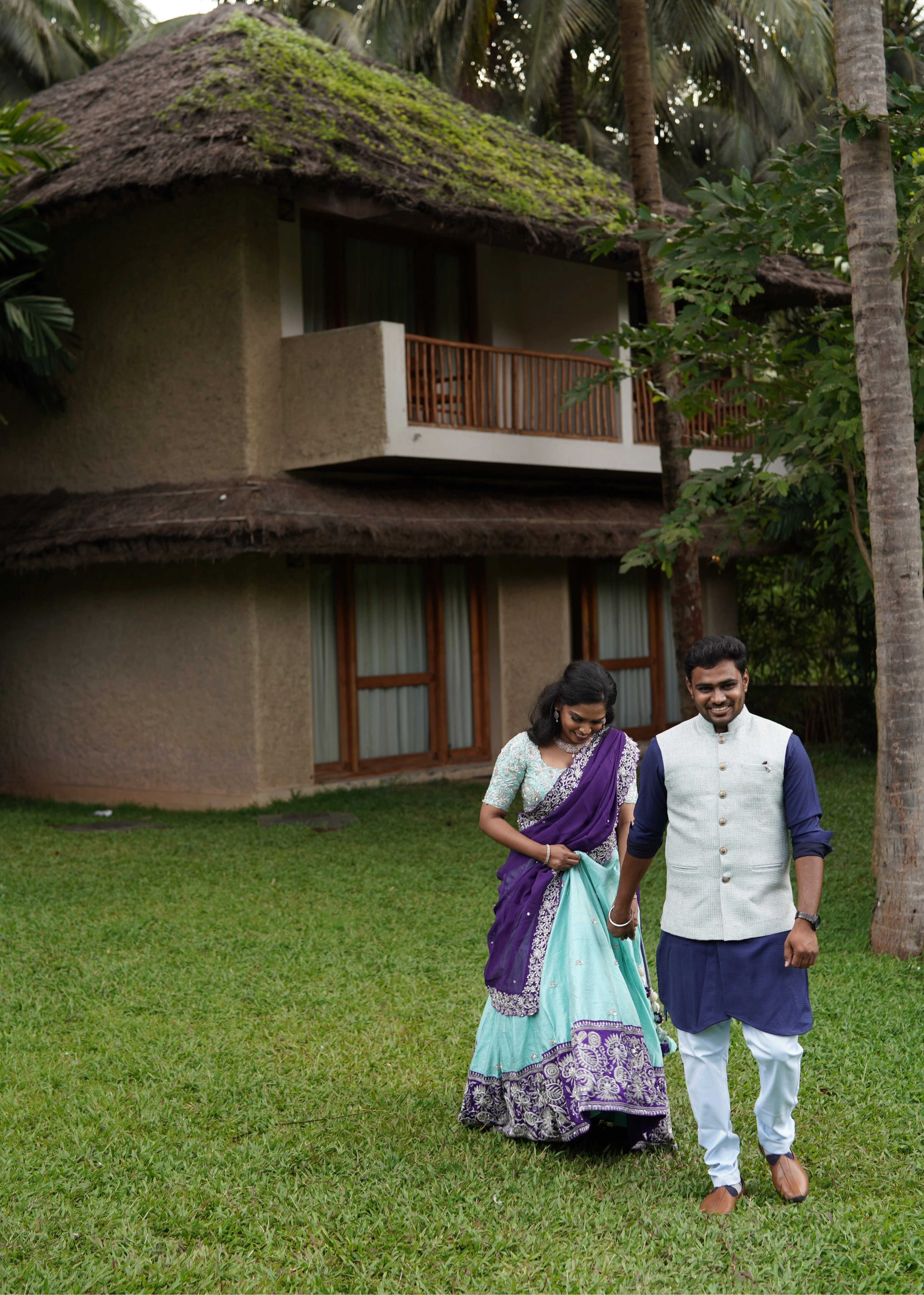 Bride smiling in blue and purple rawsilk lehenga designed by Archana Karthick