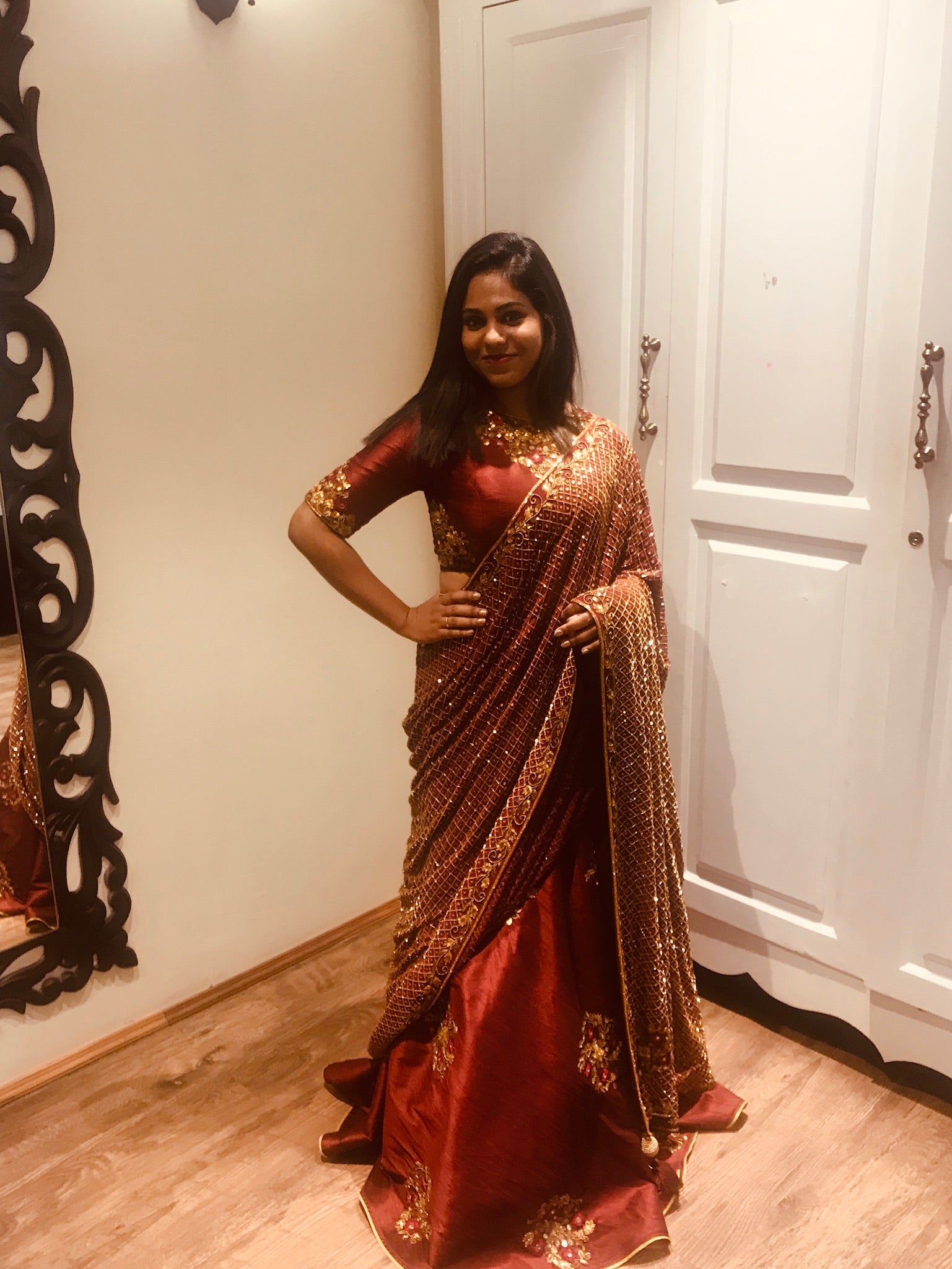 Bridesmaid Abhinaya from Trichy in a wine red rawsilk and tulle lehenga handcrafted with resham, beads, zardozi and mirror work designed by Archana Karthick.