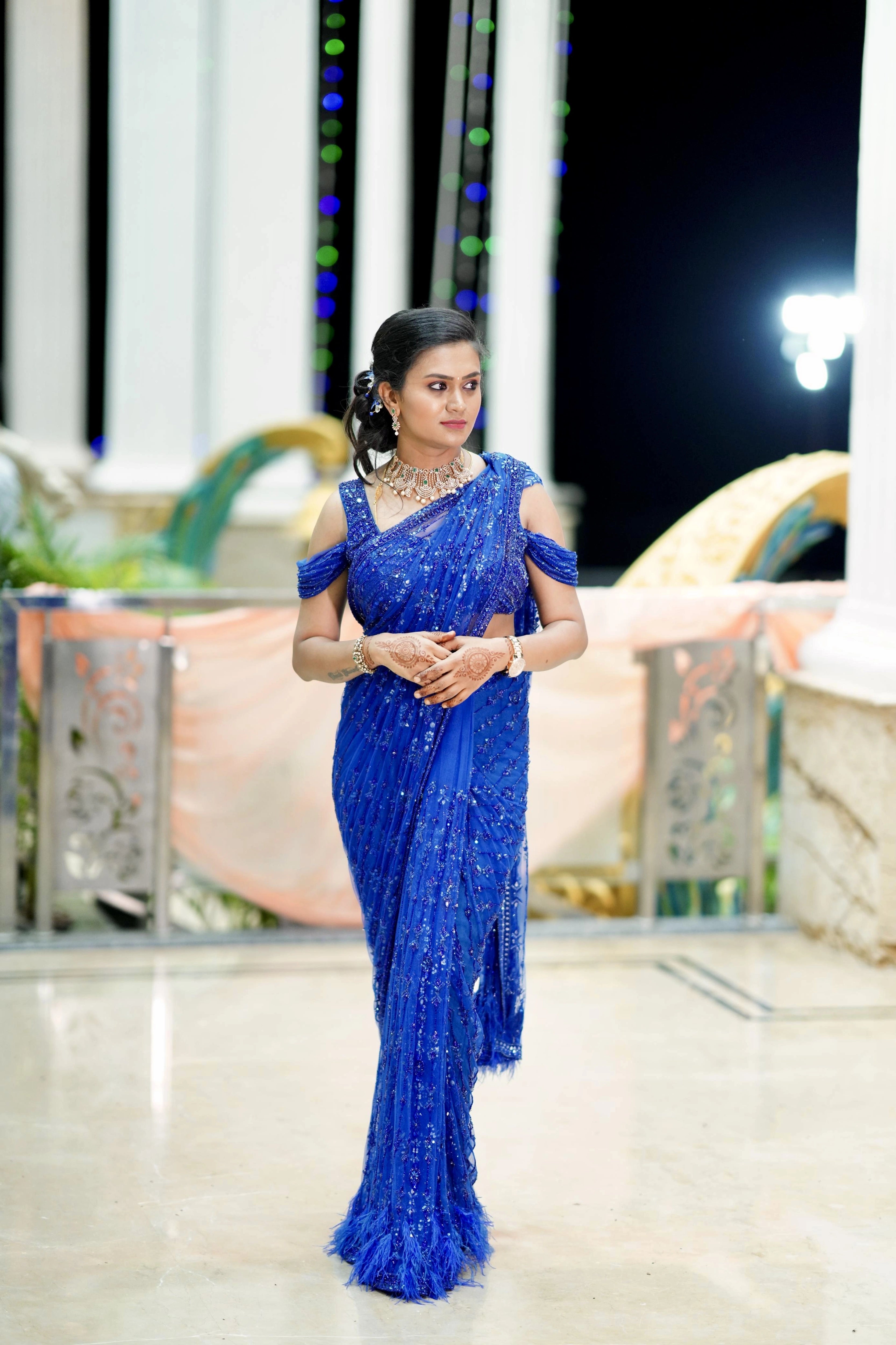 Bridesmaid Gouthami from Bangalore smiling in a blue tulle saree, handcrafted by team Archana Karthick.