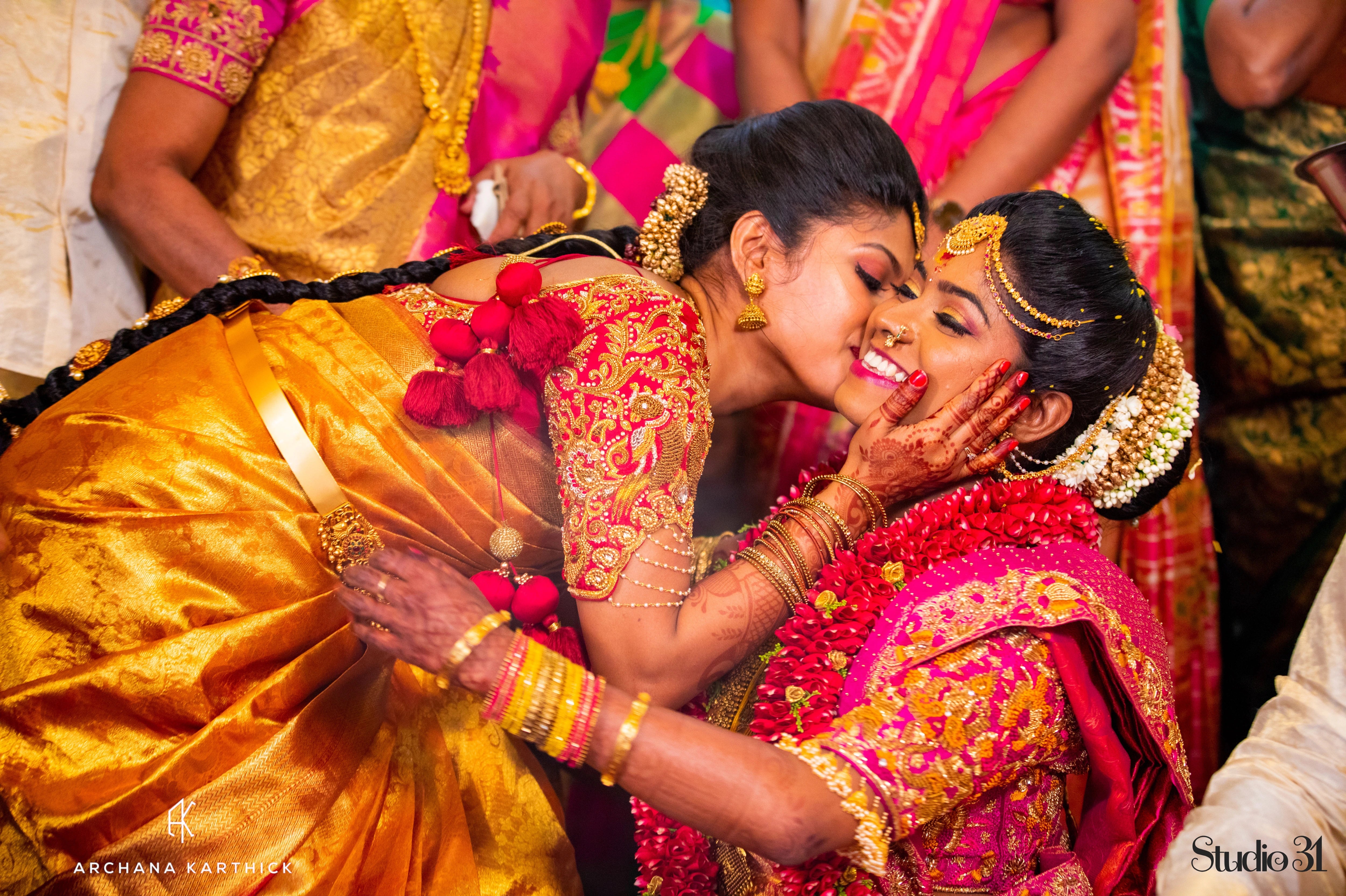 Bridesmaid Manju from Australia, with the bride in a red silk blouse by team Archana Karthick