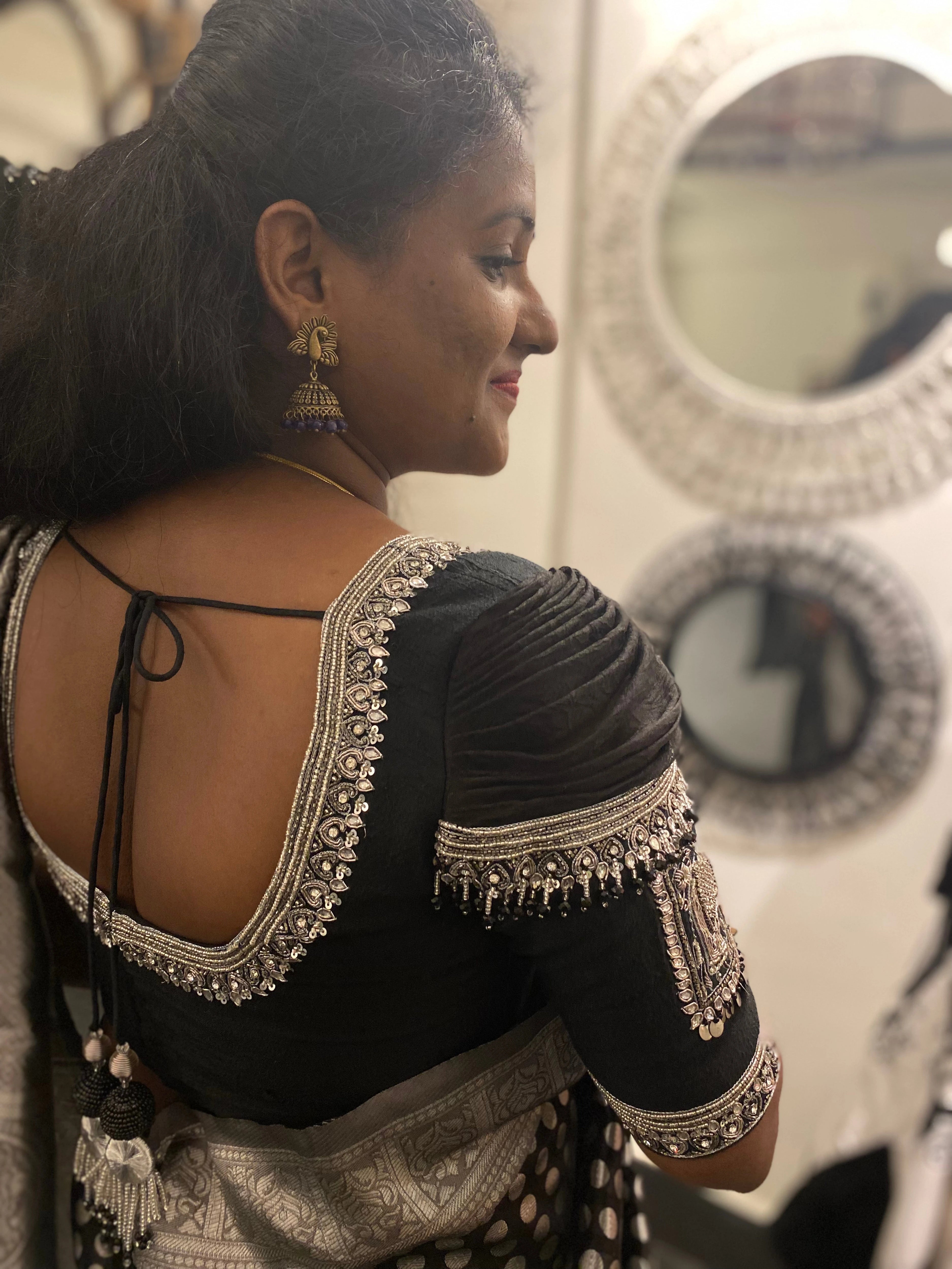 Bridesmaid Nagalakshmi during fittings in a black rawsilk blouse, handcrafted by team Archana Karthick.