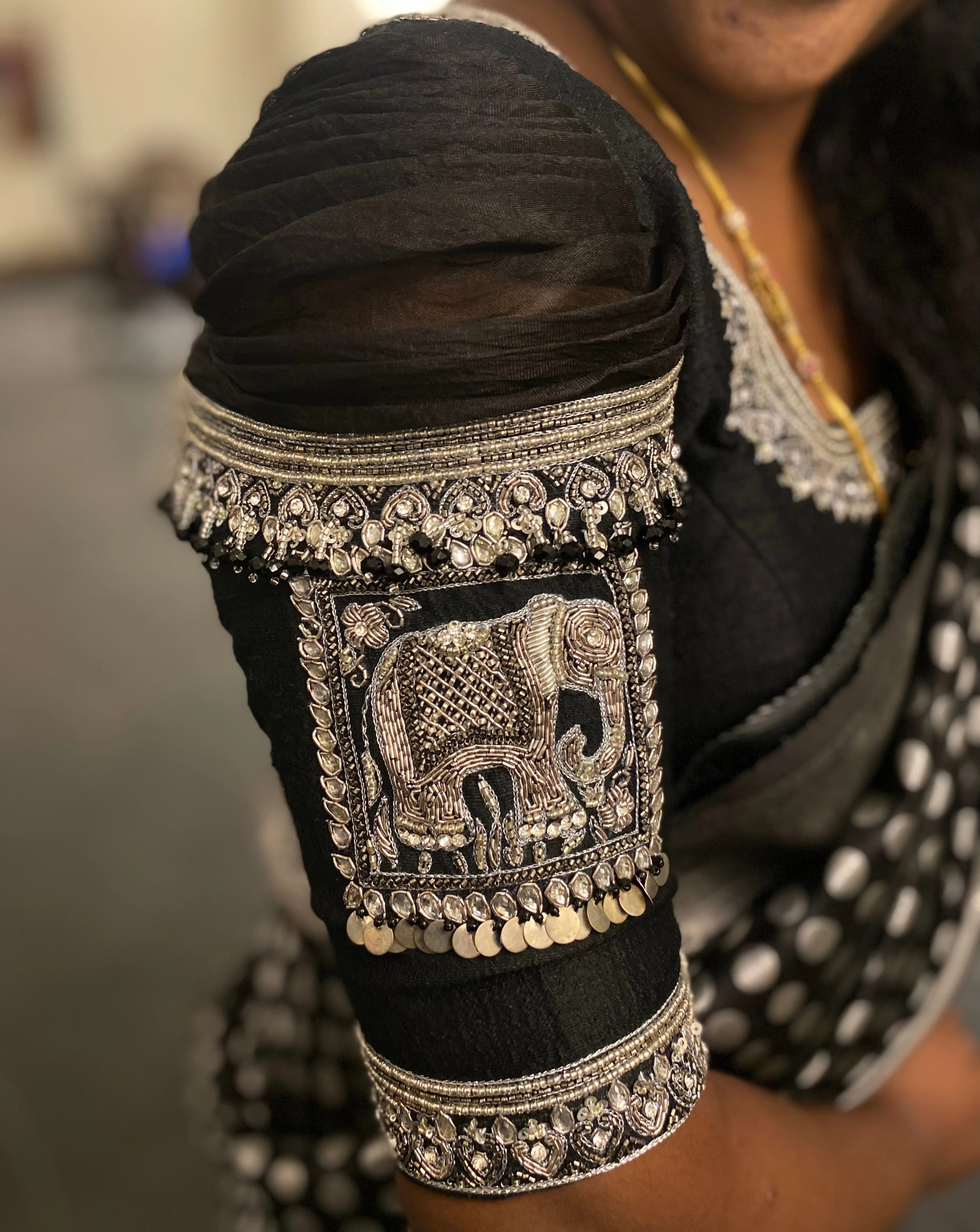 Bridesmaid Nagalakshmi in a black rawsilk blouse, handcrafted by team Archana Karthick.