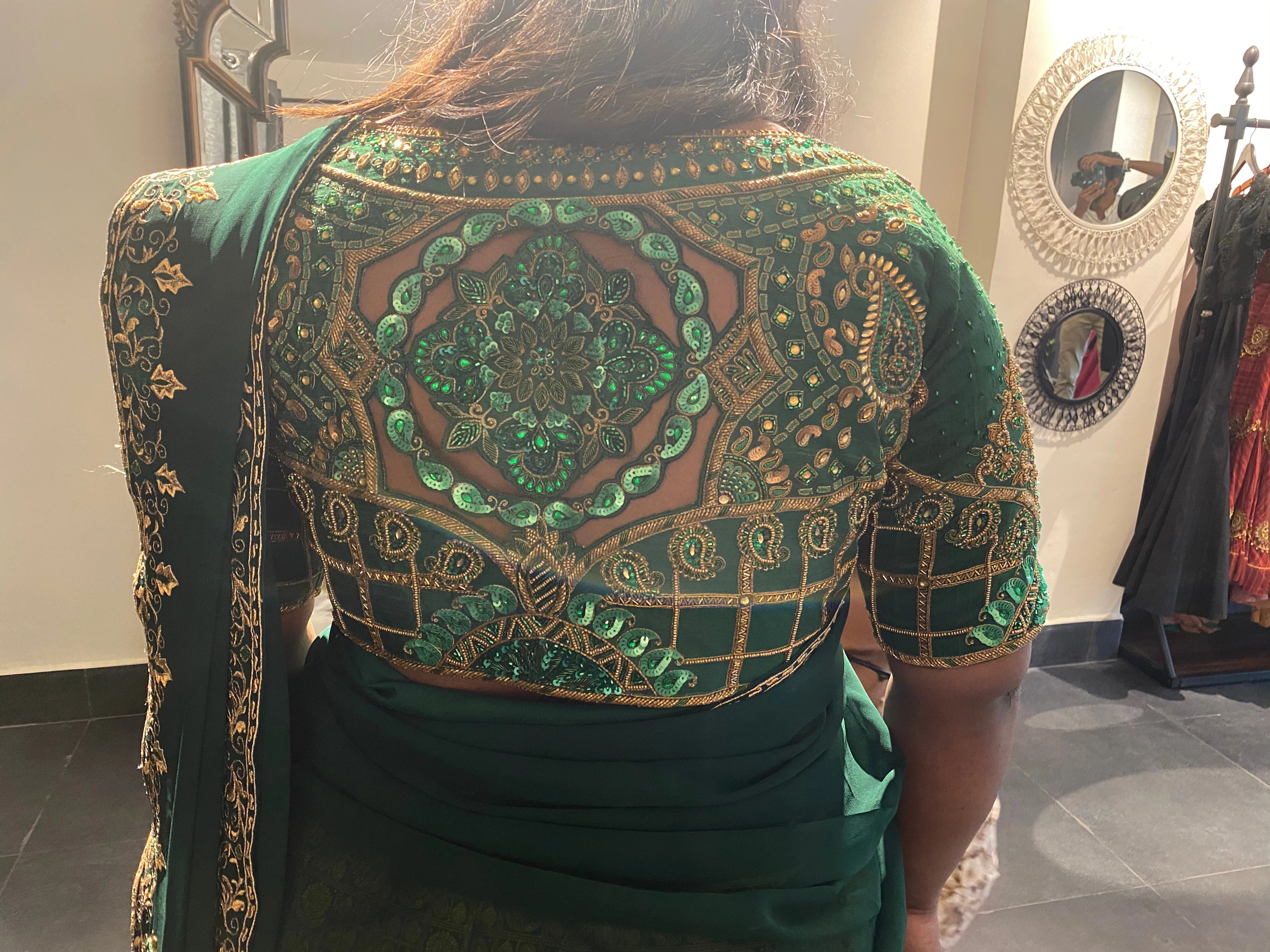 Bridesmaid Ramadevi during fittings in a green silk blouse, handcrafted by team Archana Karthick.