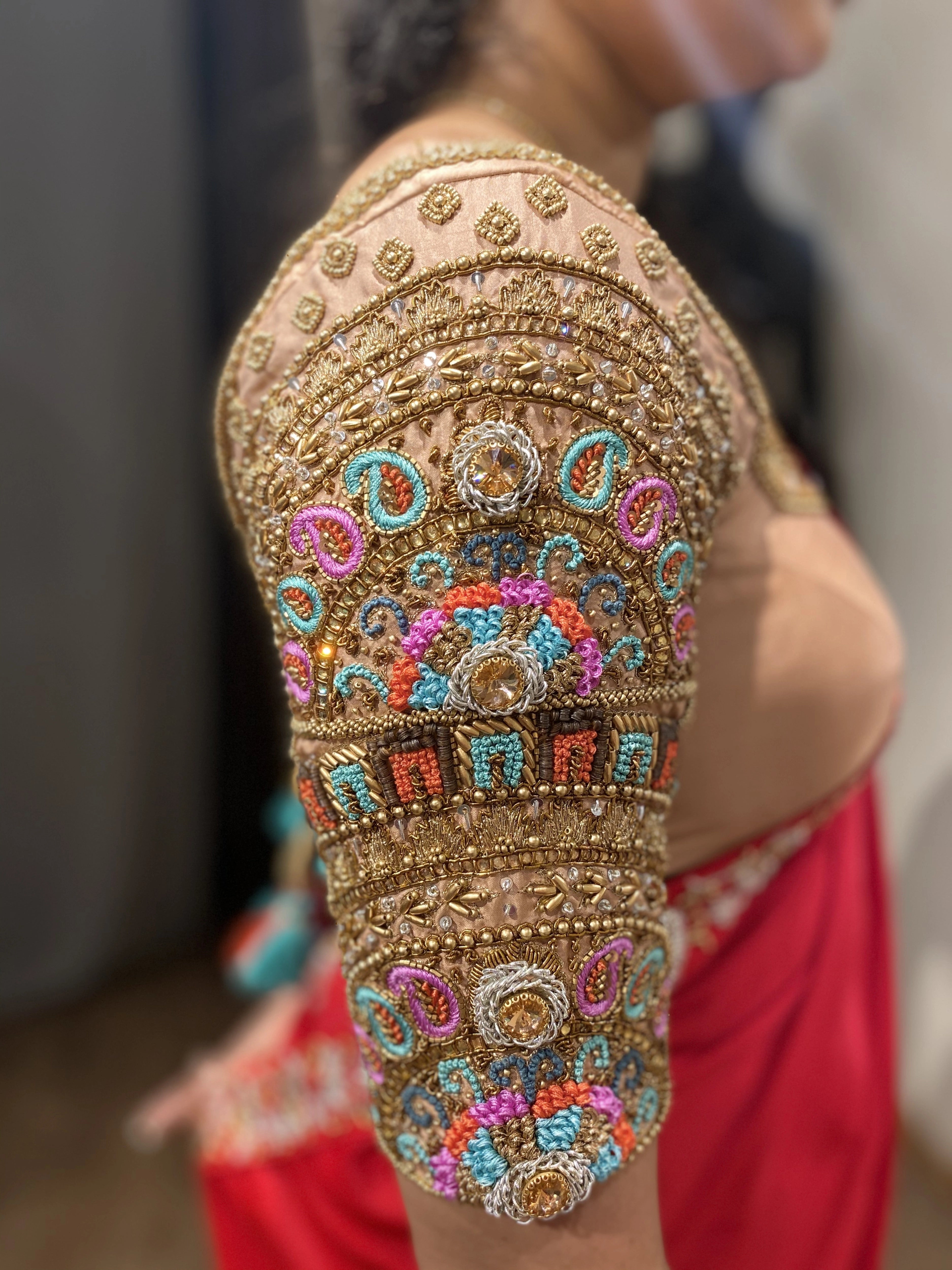 Bridesmaid Sai Teju during fittings in a peach cream silk blouse, handcrafted by team Archana Karthick.