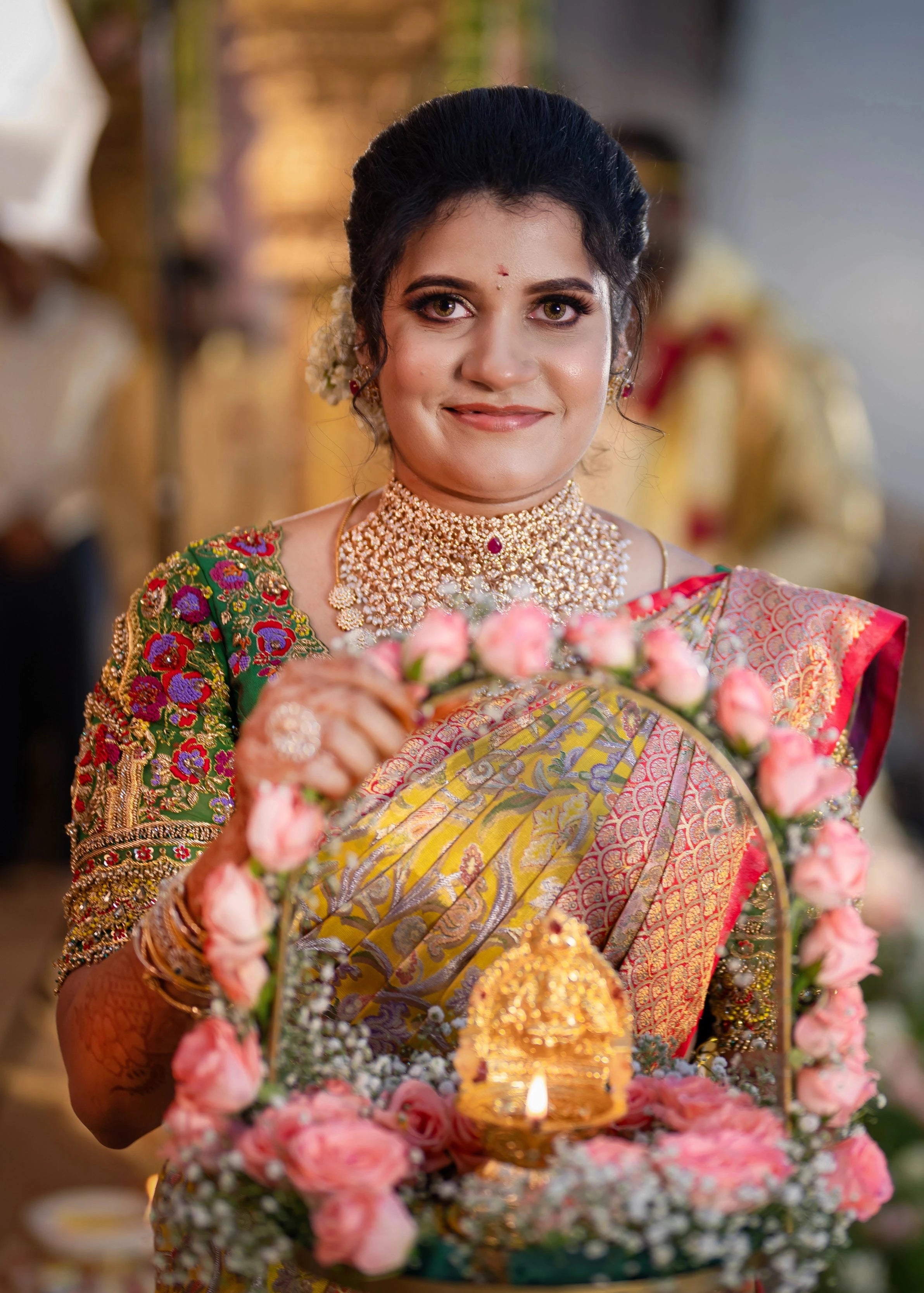 Bridesmaid Sanjana Sujith in a green silk blouse intricately handcrafted with resham, zardozi, sequins, beads, crystals and stones by Archana Karthick.
