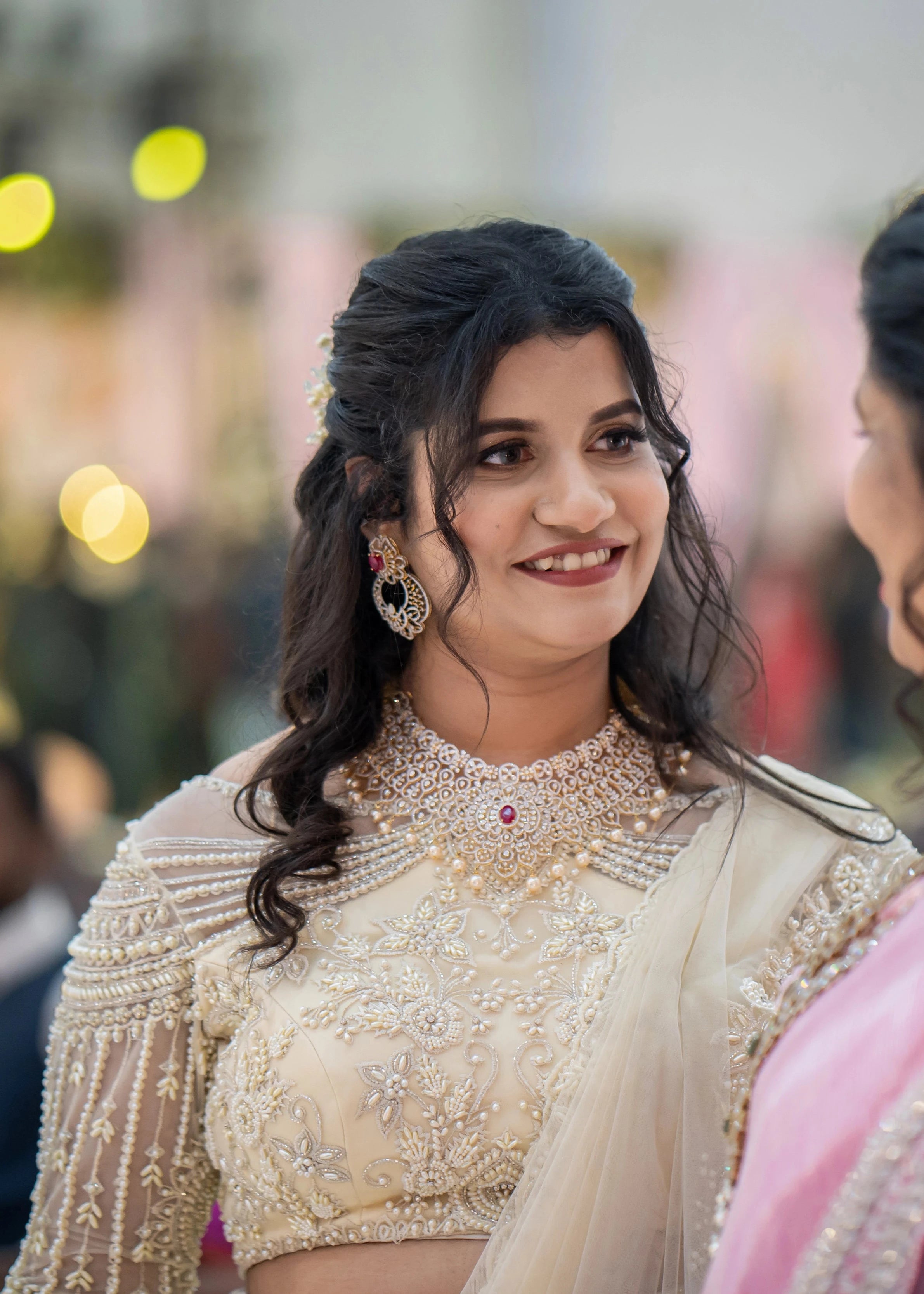 Bridesmaid Sanjana Sujith in a white mermaid tulle draped lehenga by team Archana Karthick.