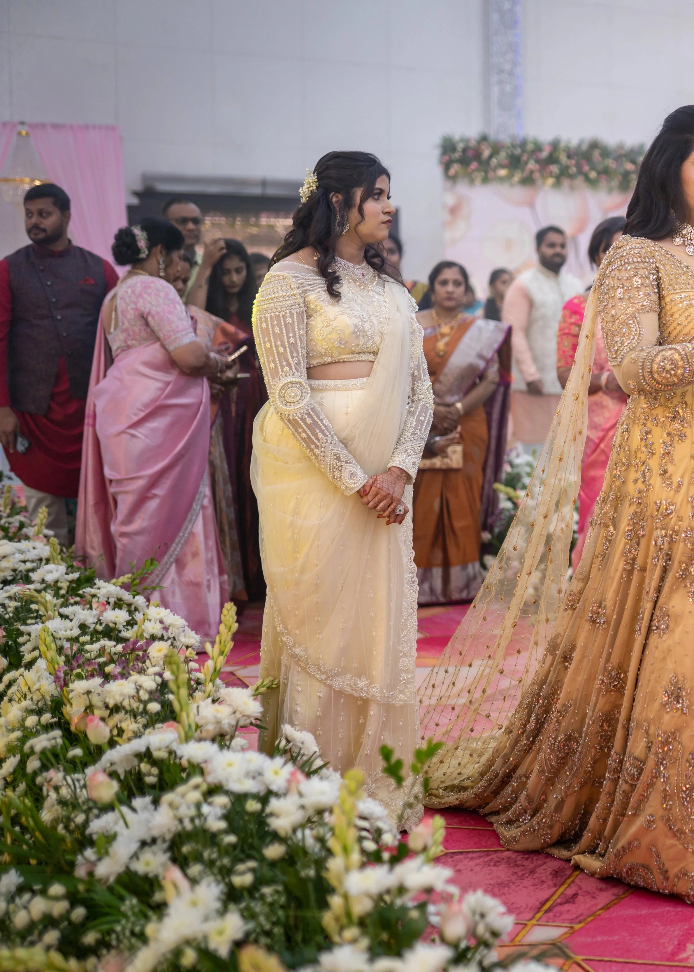 Bridesmaid Sanjana Sujith looking in a white mermaid tulle draped lehenga by team Archana Karthick.