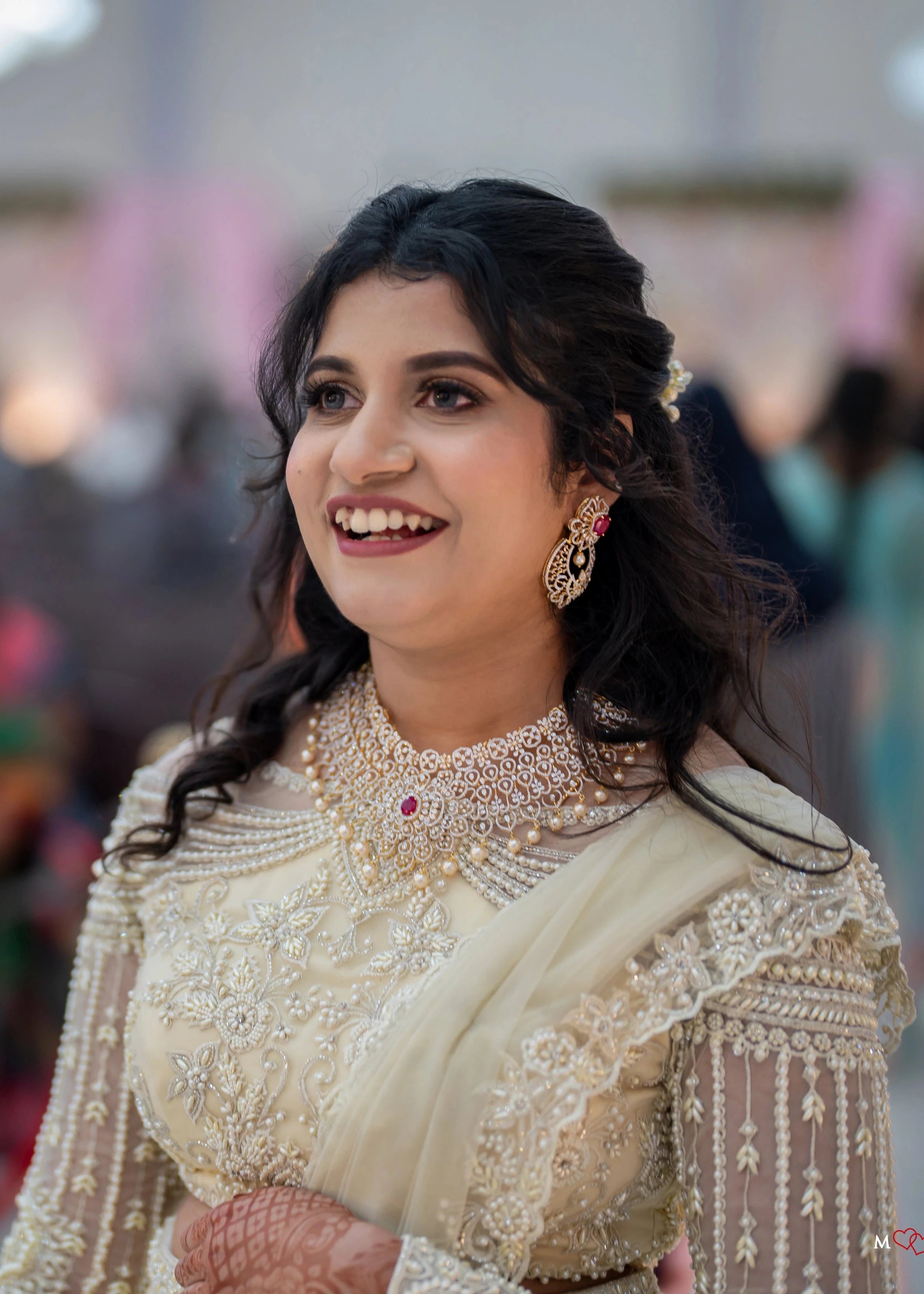 Bridesmaid Sanjana Sujith smiling in a white mermaid tulle draped lehenga by team Archana Karthick.