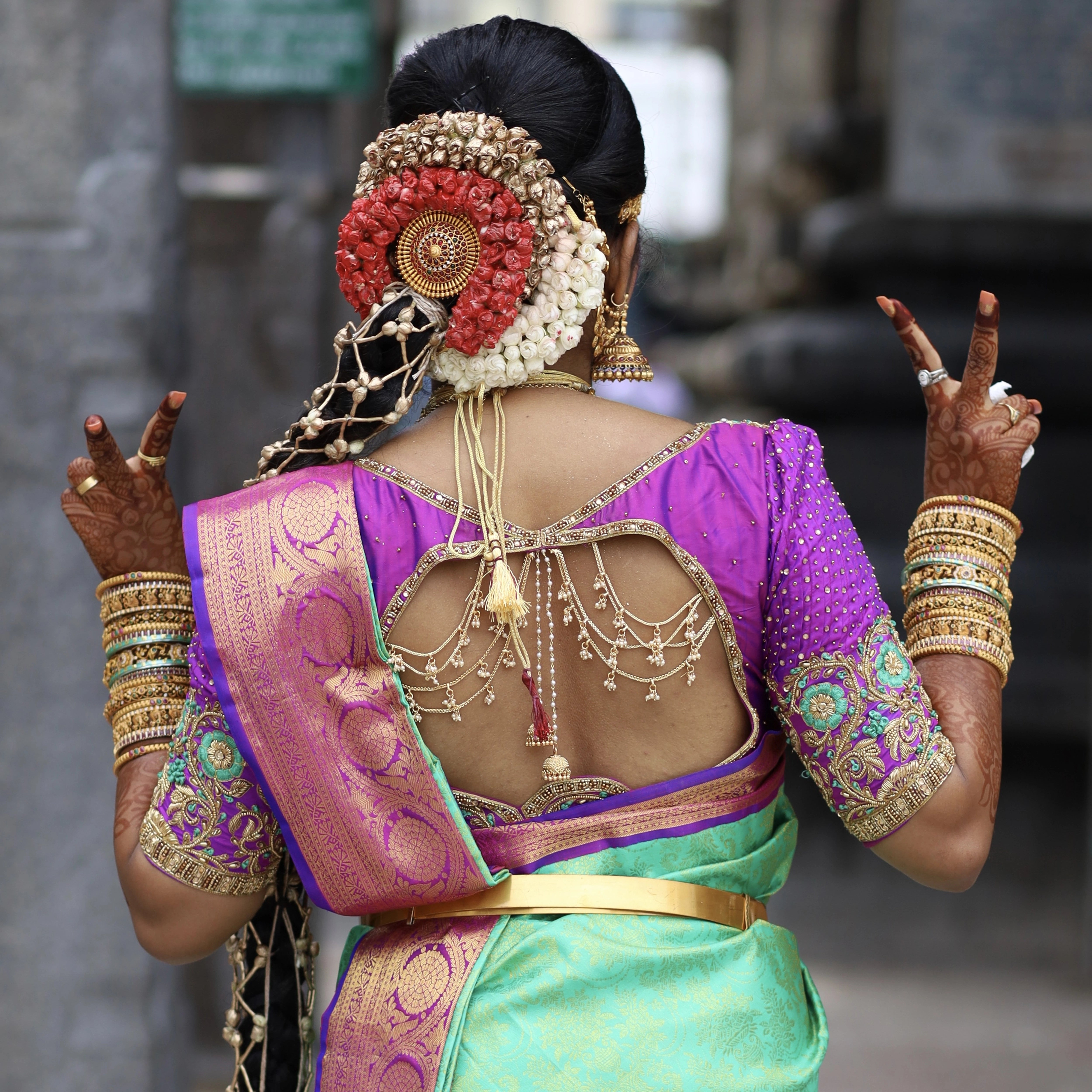 Classical Dancer Preethi Shiva posing in a magenta silk blouse for her engagement, handcrafted with zardozi, stones, beads, jhumka and resham by team Archana Karthick.