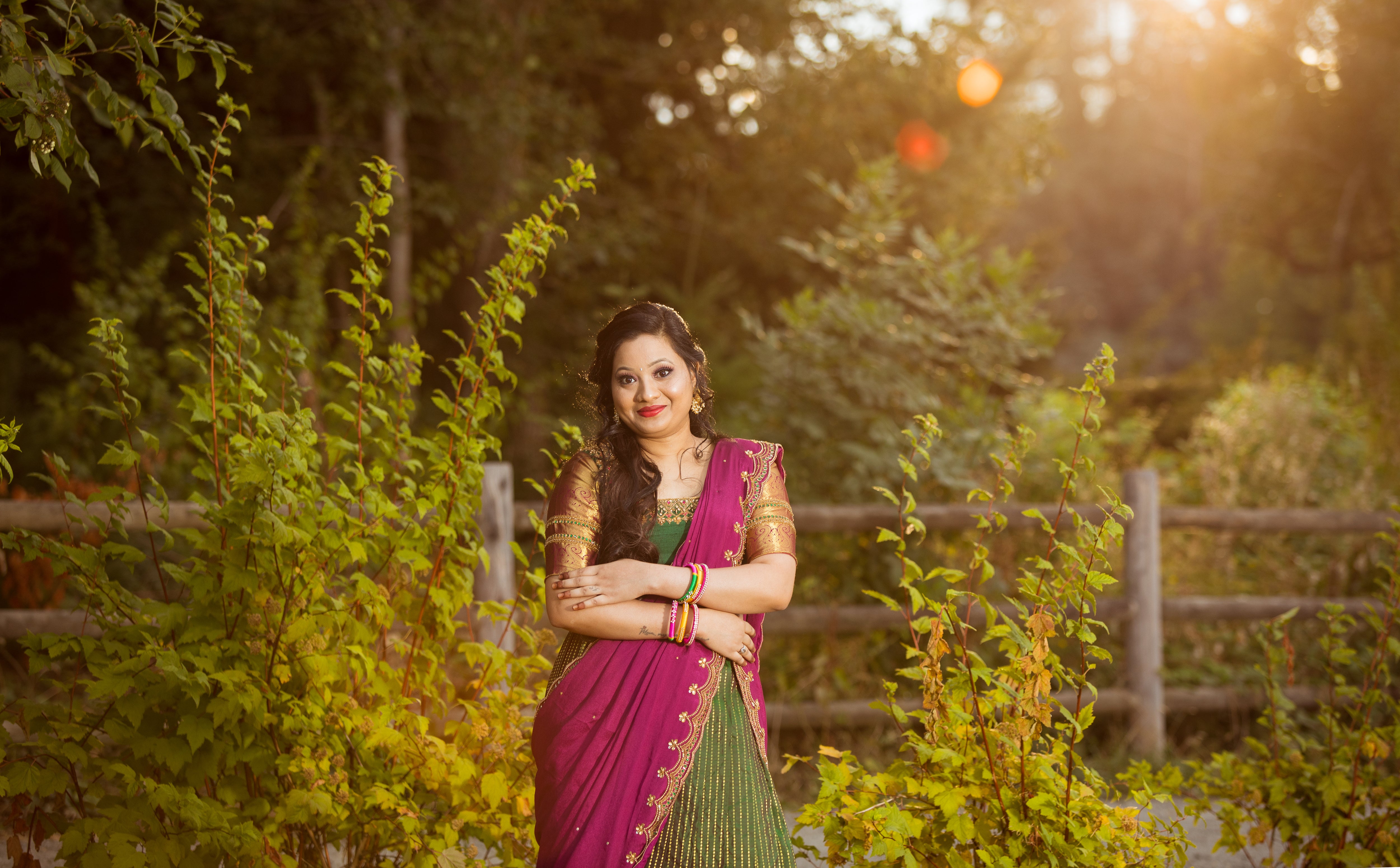 Client, Swathi Pillai, from Seattle front profile posing in a bottle green and magenta silk traditional half saree designed by archana karthick.