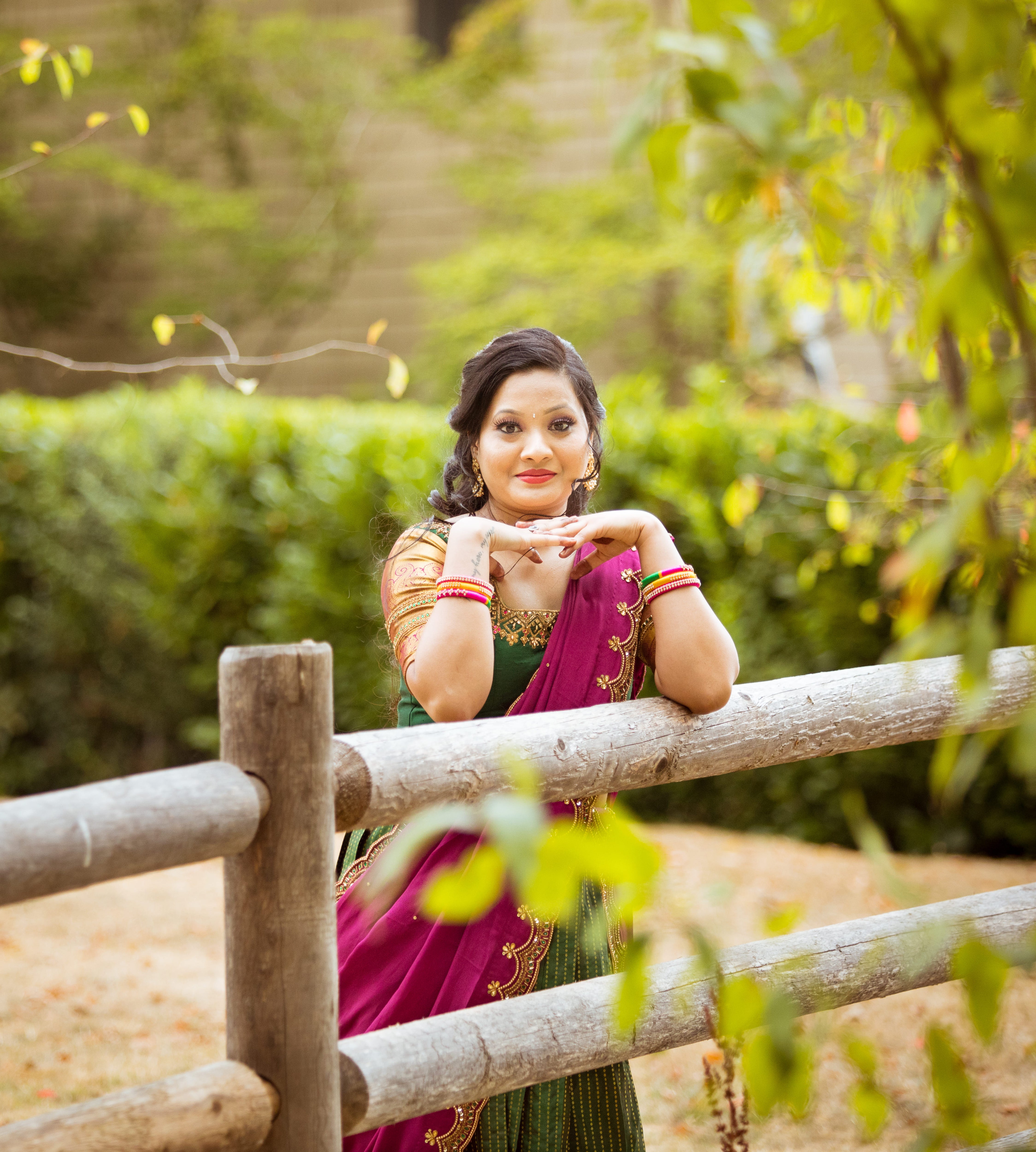 Client from Seattle posing in a bottle green and magenta silk traditional half saree designed by archana karthick
