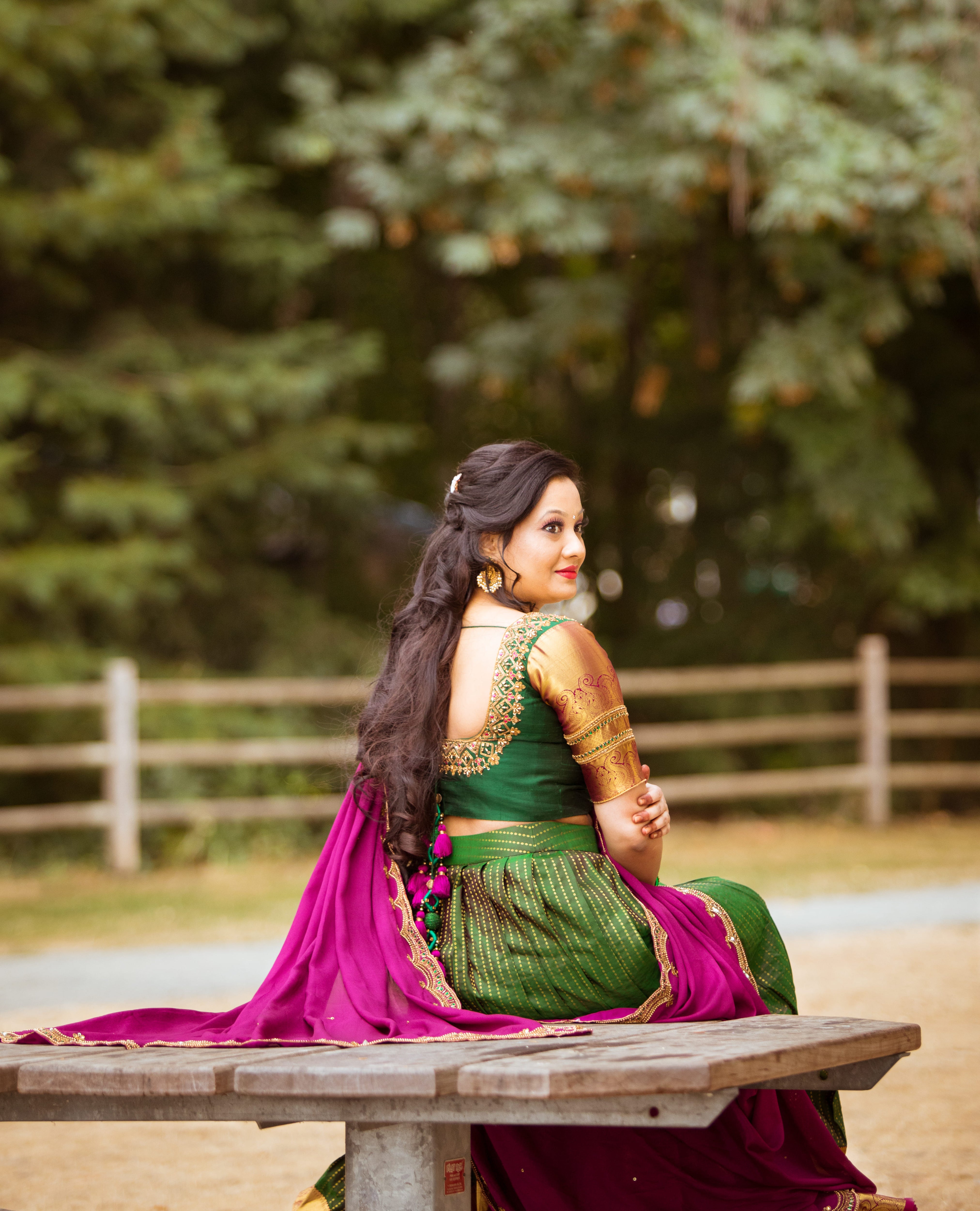 Client from Seattle showing back blouse design of a bottle green and magenta silk traditional half saree designed by archana karthick