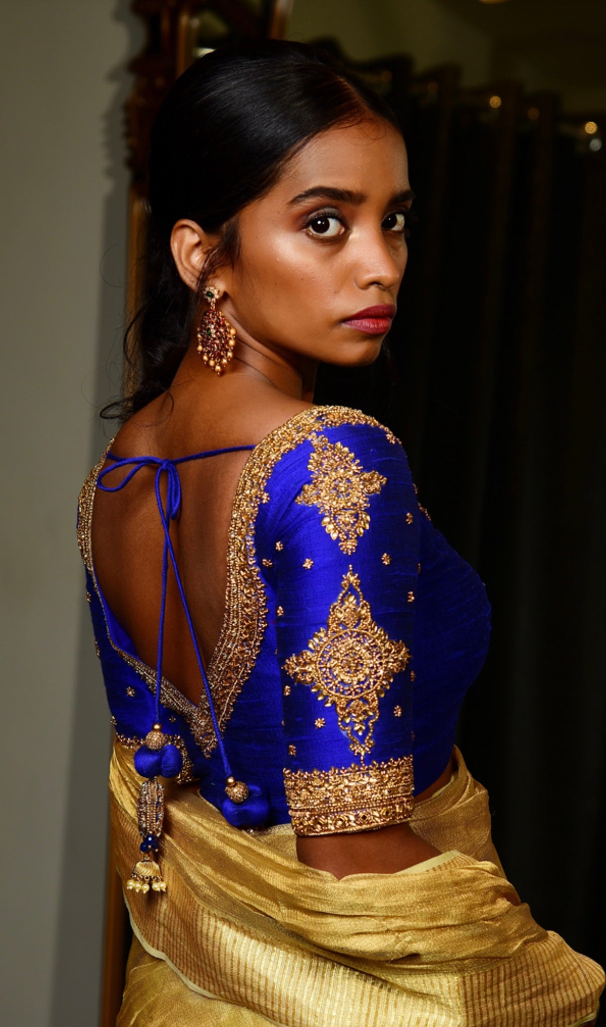 Model in Handcrafted Raw Silk blouse in blue with intricate zardozi work on the sleeves and neckline designed by Archana Karthick.
