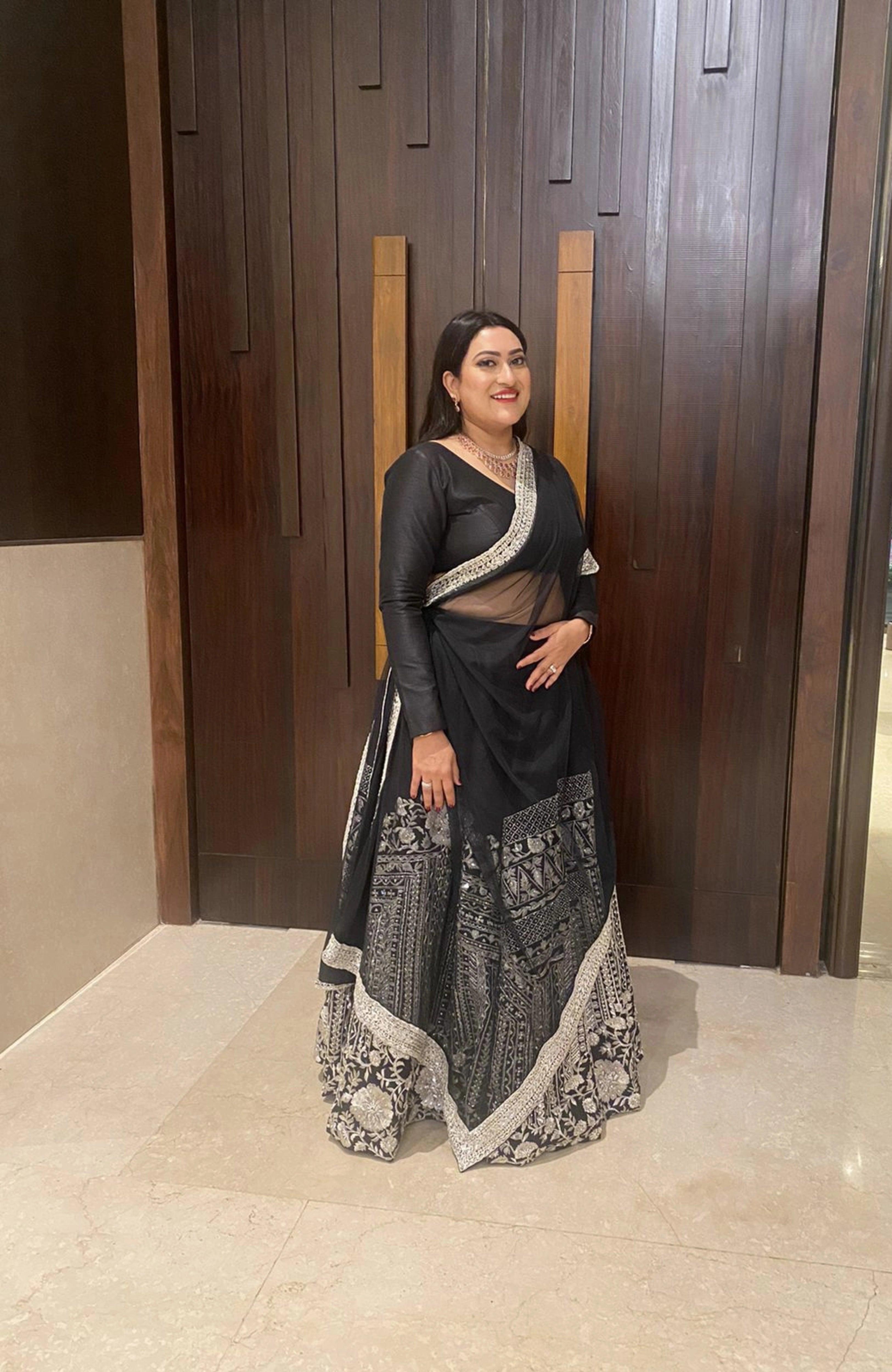 Dr Priya from USA, in a black and silver raw silk lehenga, handcrafted by team Archana Karthick.