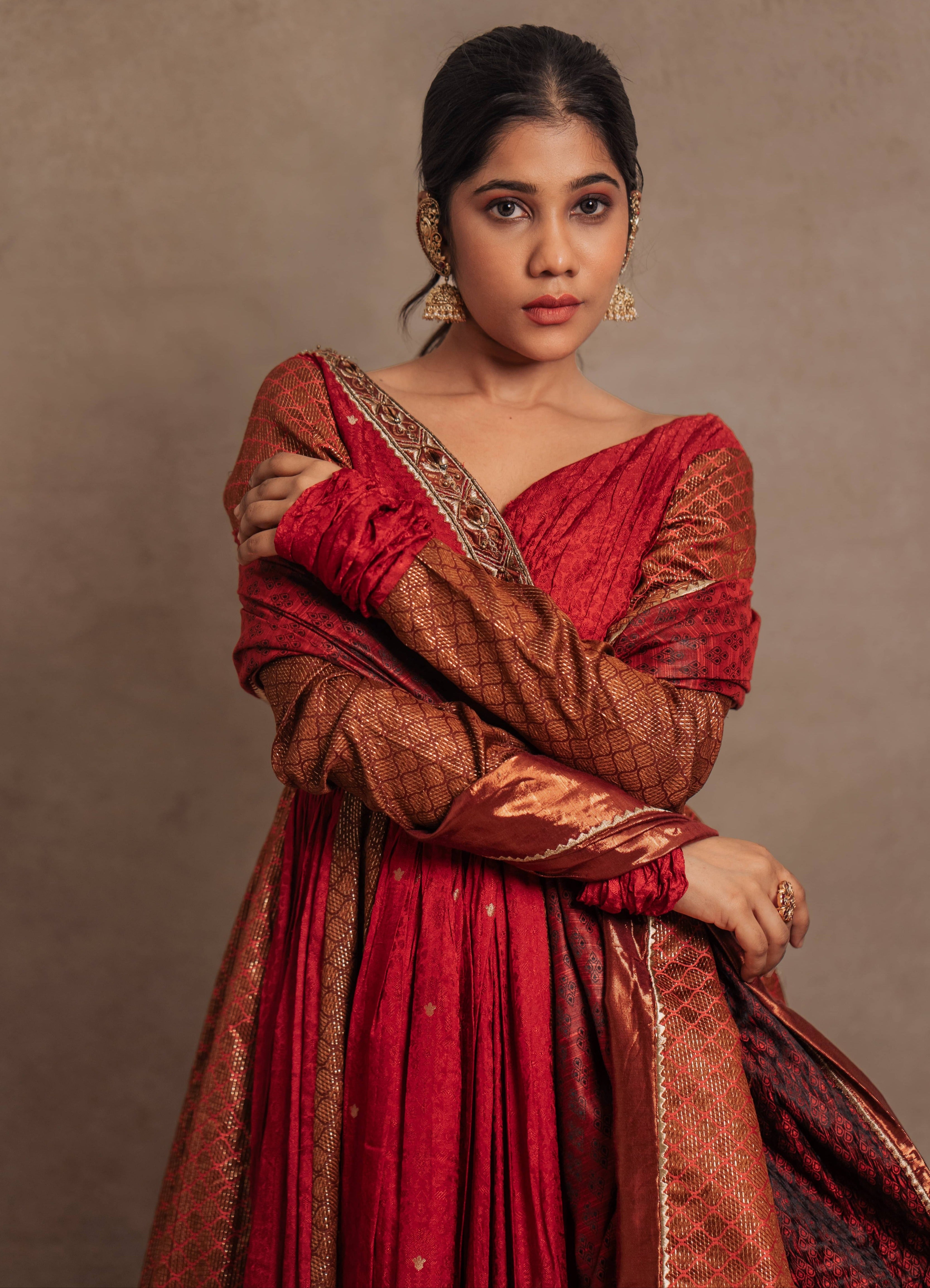 Dupatta design details of a Red-orange angrakha anarkali in banarasi tissue and silk paired with a sharara pant and a delicate tissue dupatta by team Archana Karthick