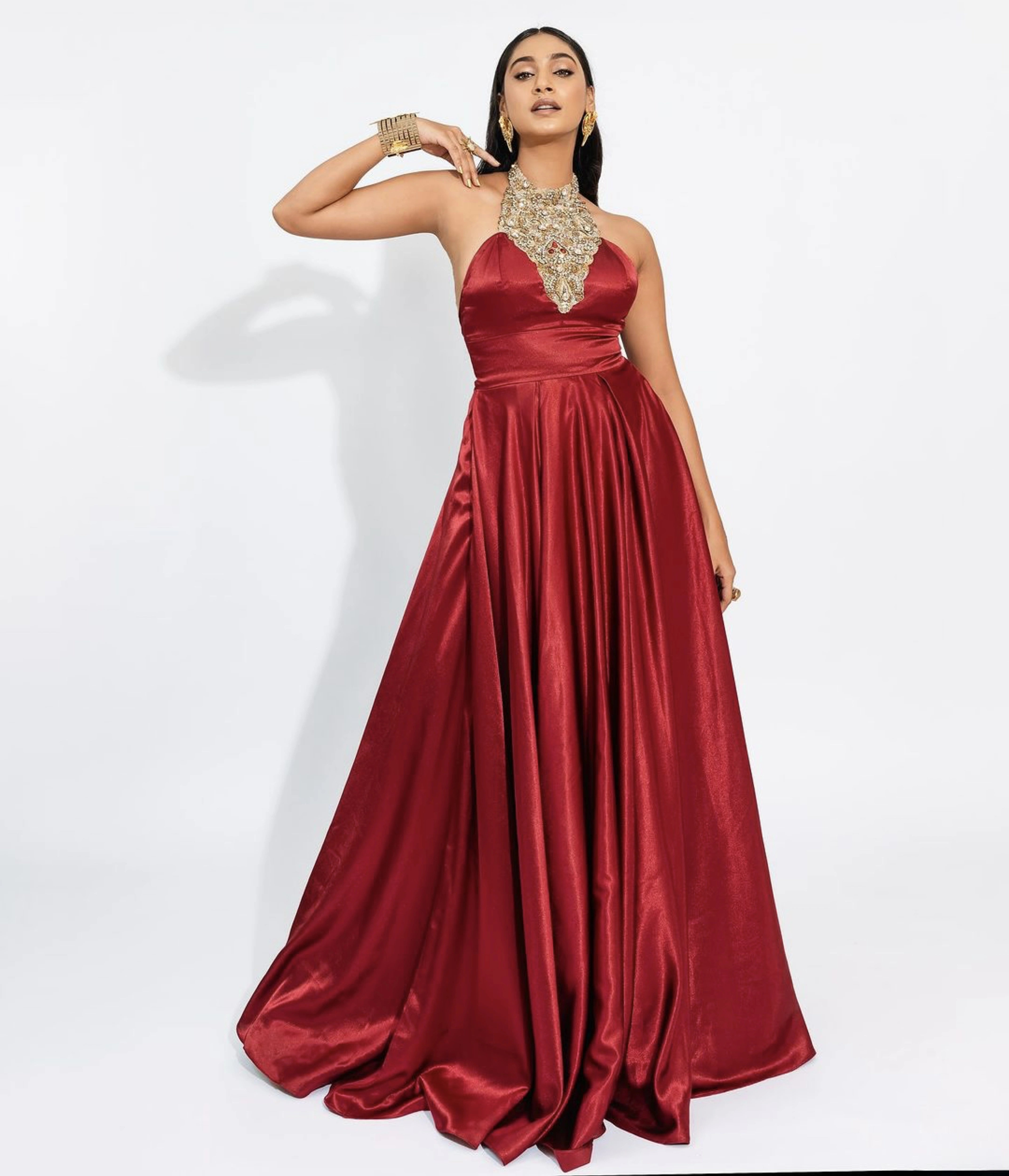 Former Miss India and Actress Anukreethy Vas for a photoshoot in a red satin silk bejewled halterneck gown by team Archana Karthick.