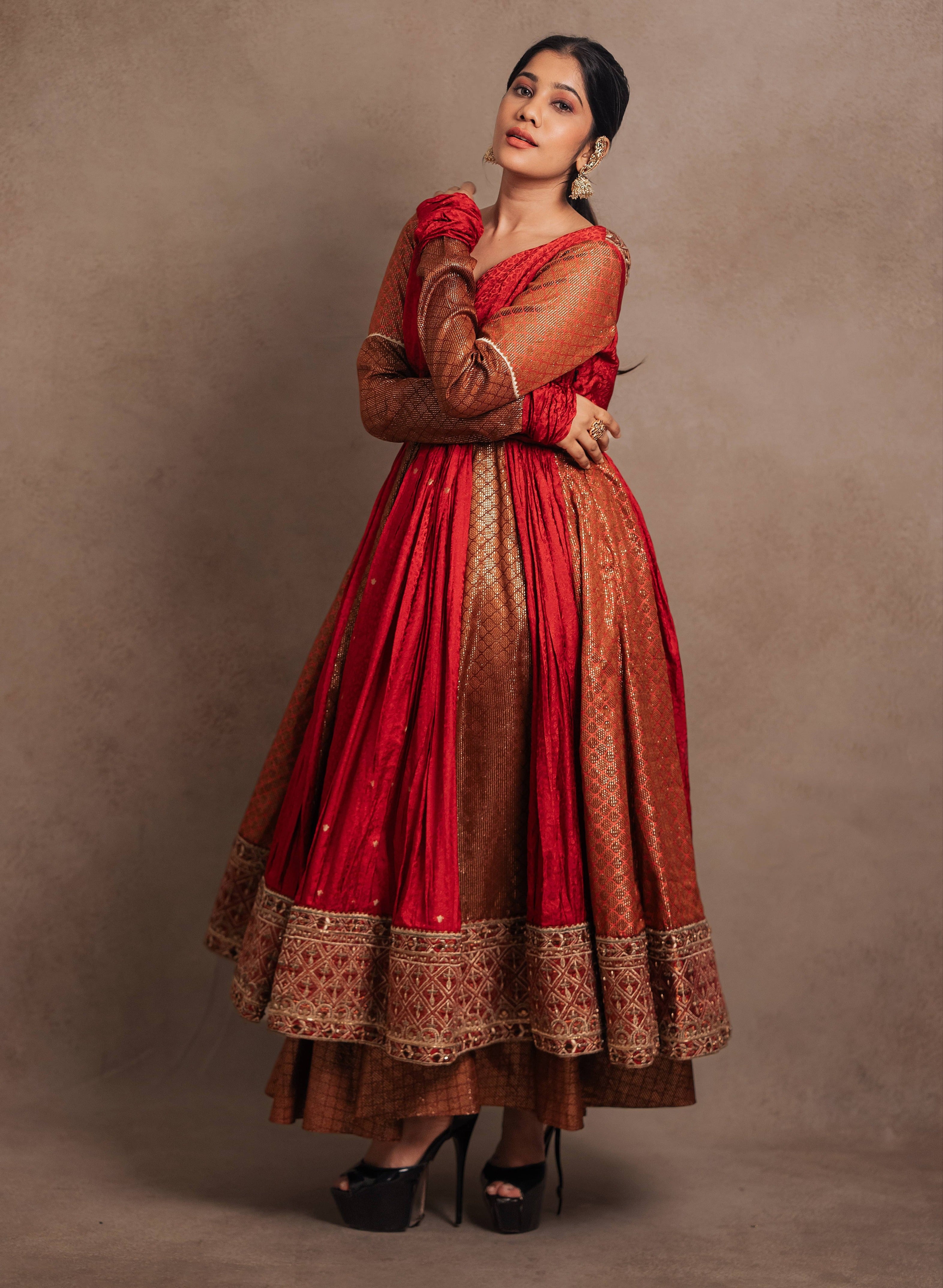 Full front design details of a Red-orange angrakha anarkali in banarasi tissue and silk paired with a sharara pant and a delicate tissue dupatta by team Archana Karthick
