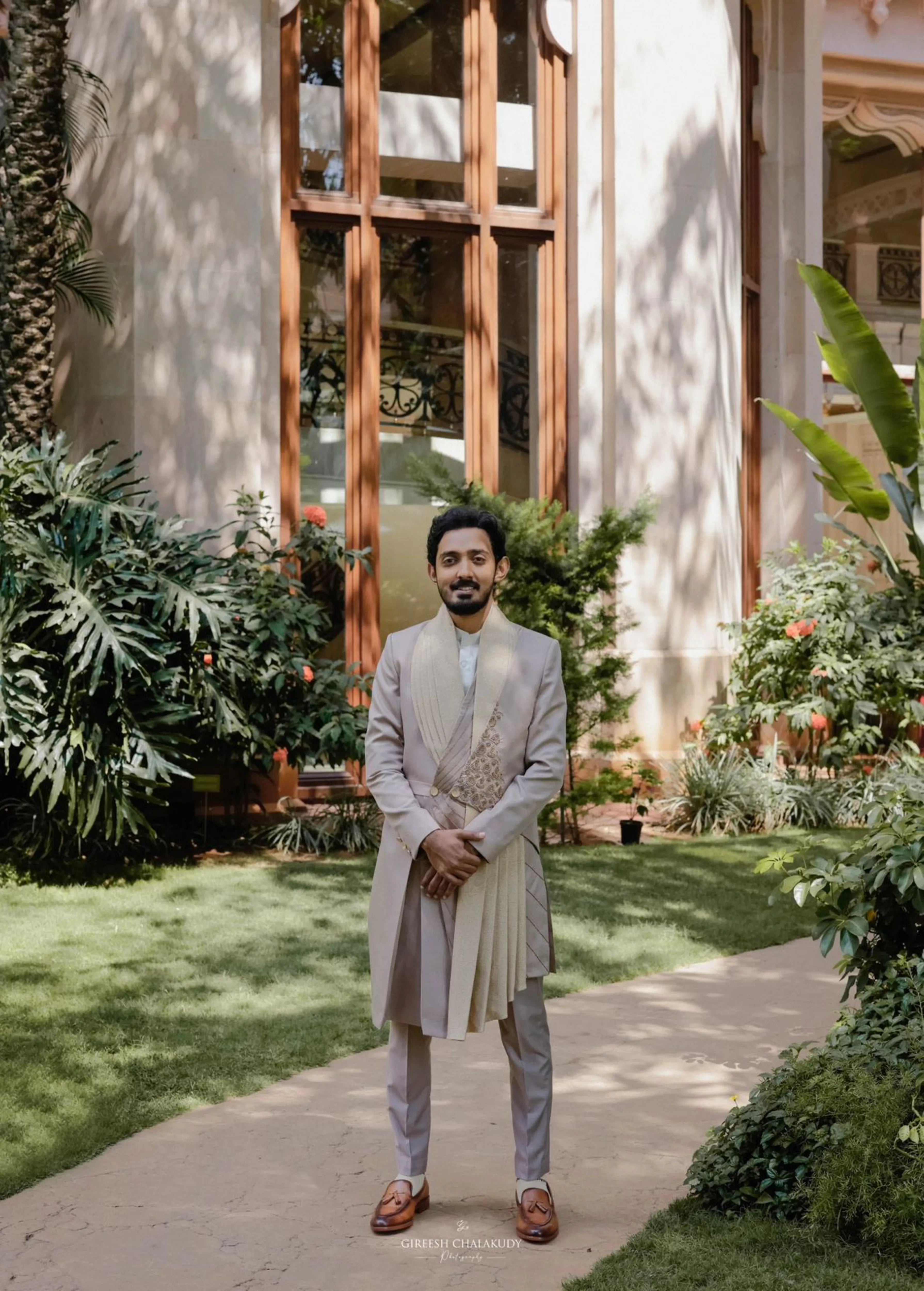 Groom Dr Mehal from Cochin posing in a beige indowestern sherwani handcrafted by team Archana Karthick.