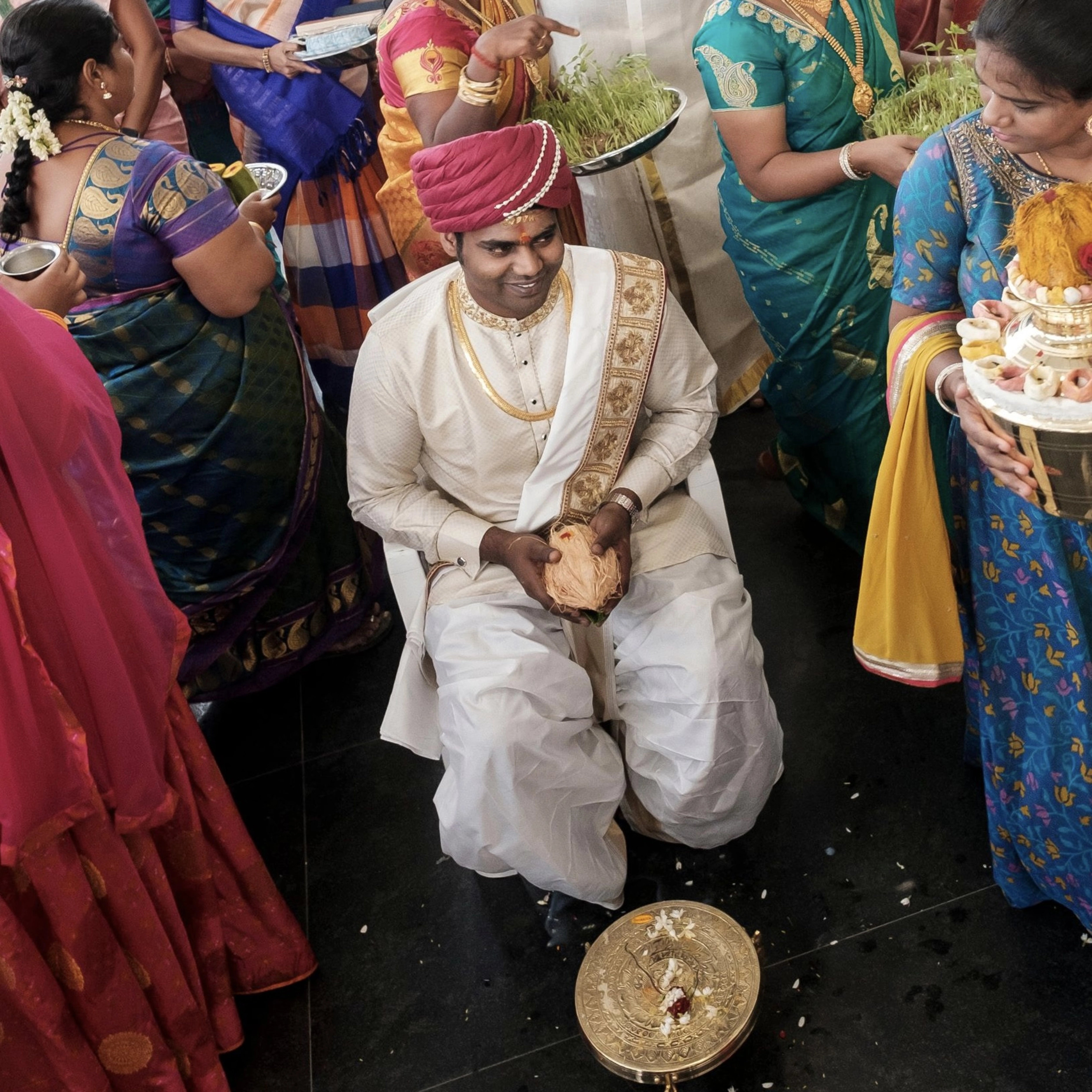 Groom Gowtham in a silk panchakacham suit, shawl and turban striking a pose for his wedding, intricately handcrafted with zardosi, resham, zari and sequins by team Archana Karthick.