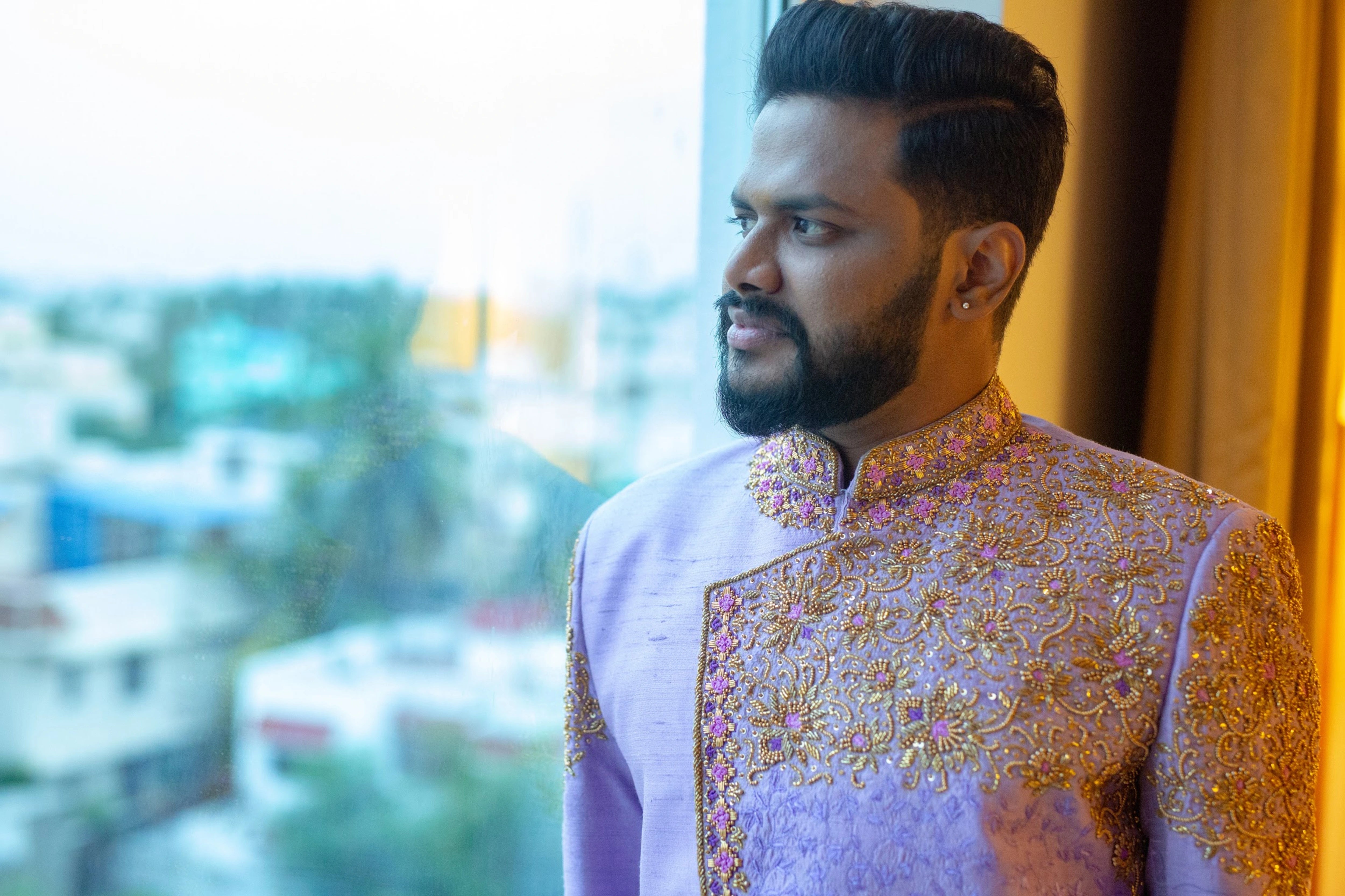 Groom Nirmal Kumar posing in an indowestern sherwani intricately handcrafted with resham, beads and sequins by team Archana Karthick.