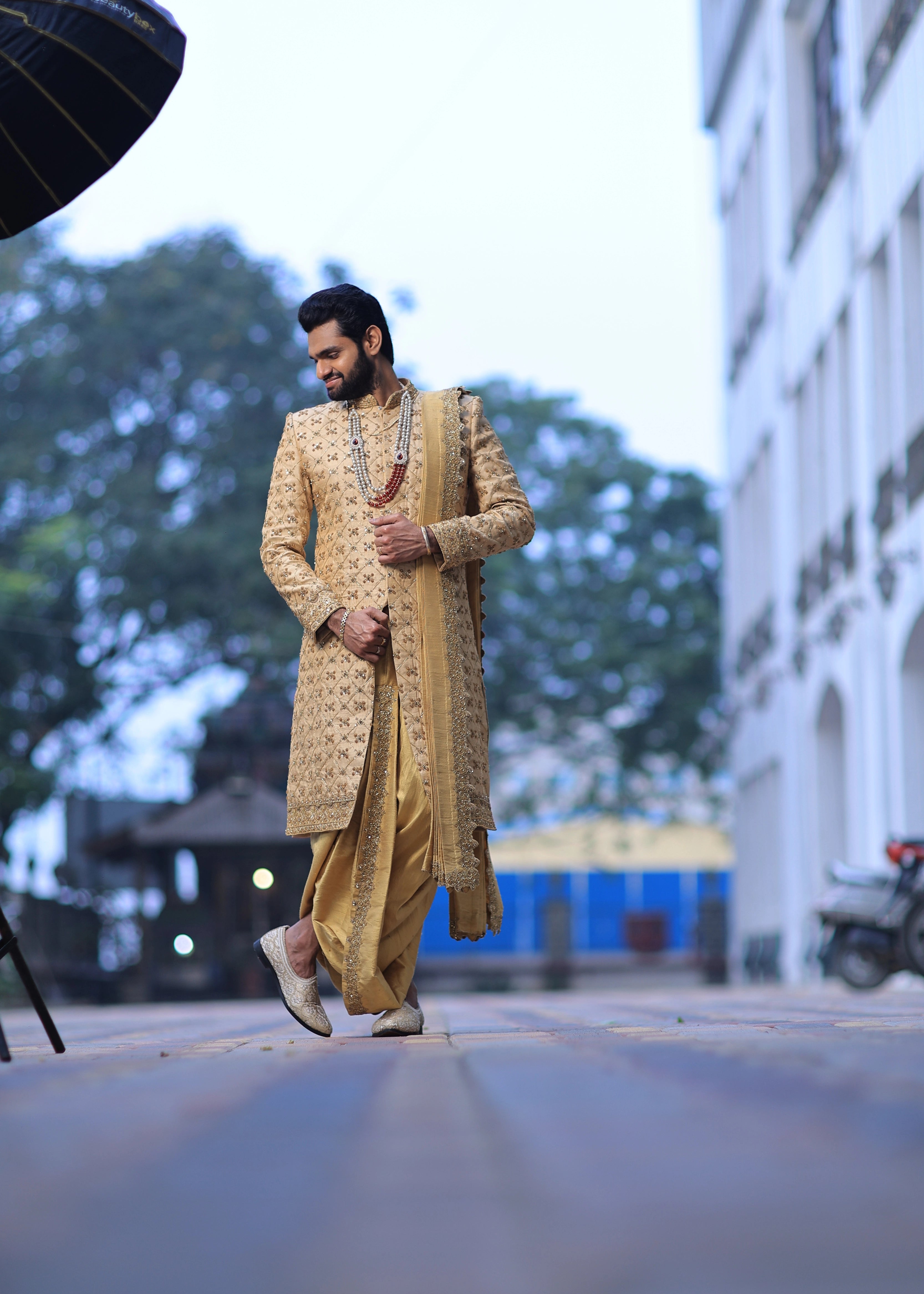 Groom from Canada in handcrafted gold sherwani by Archana Karthick
