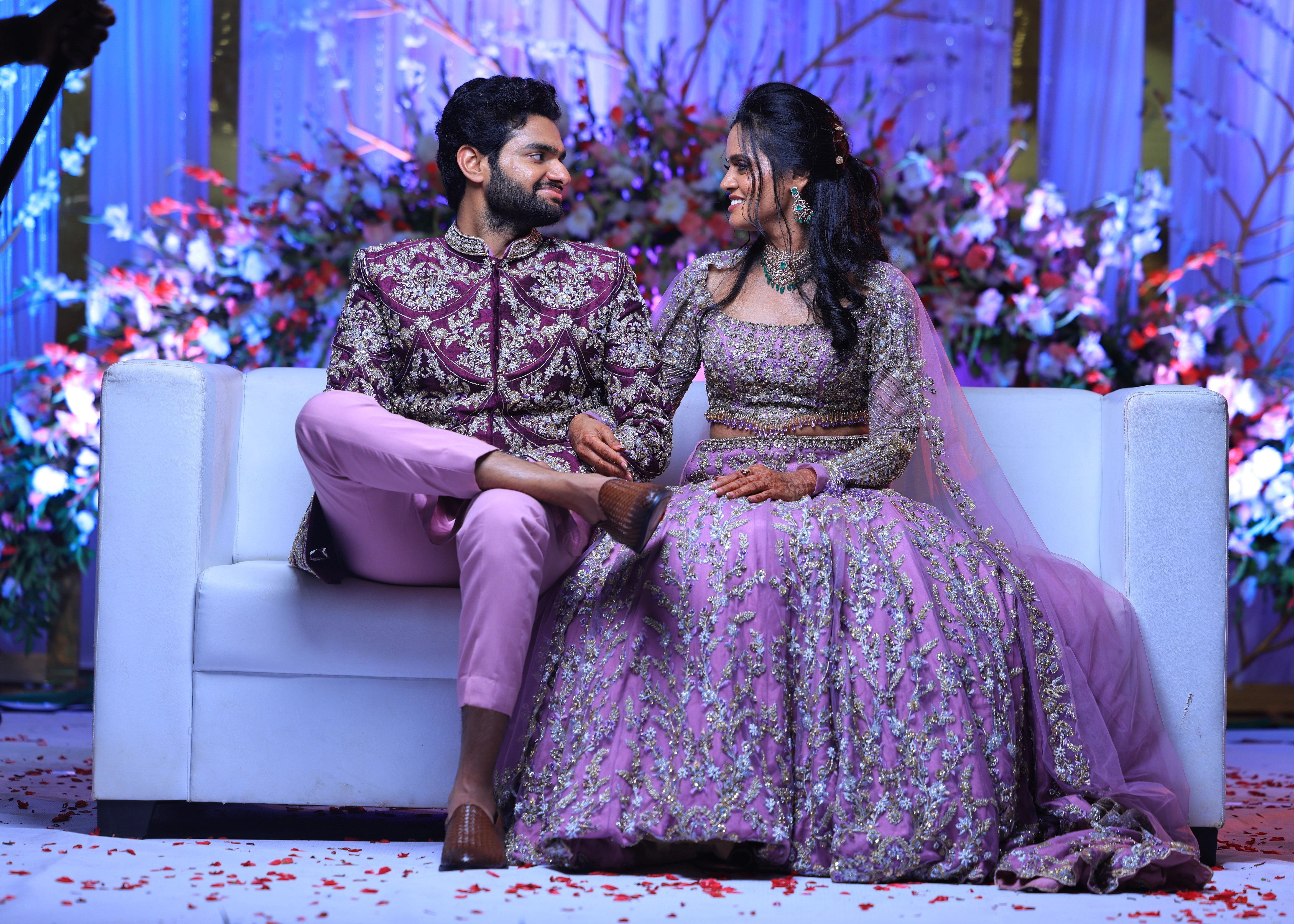 Groom from Canada smiling in handcrafted purple sherwani by Archana Karthick