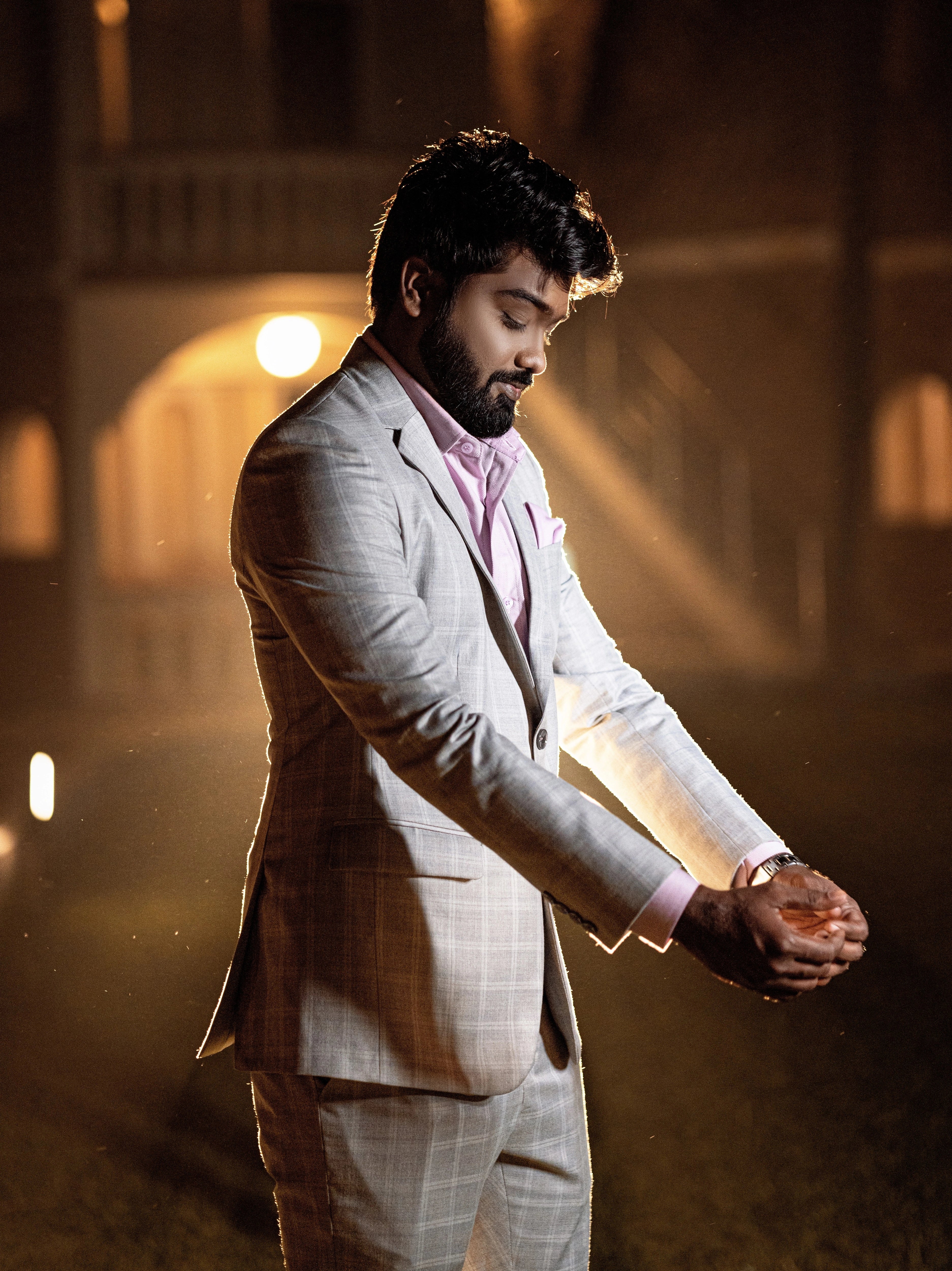 Groom in a custom three piece gray suit designed by Archana Karthick