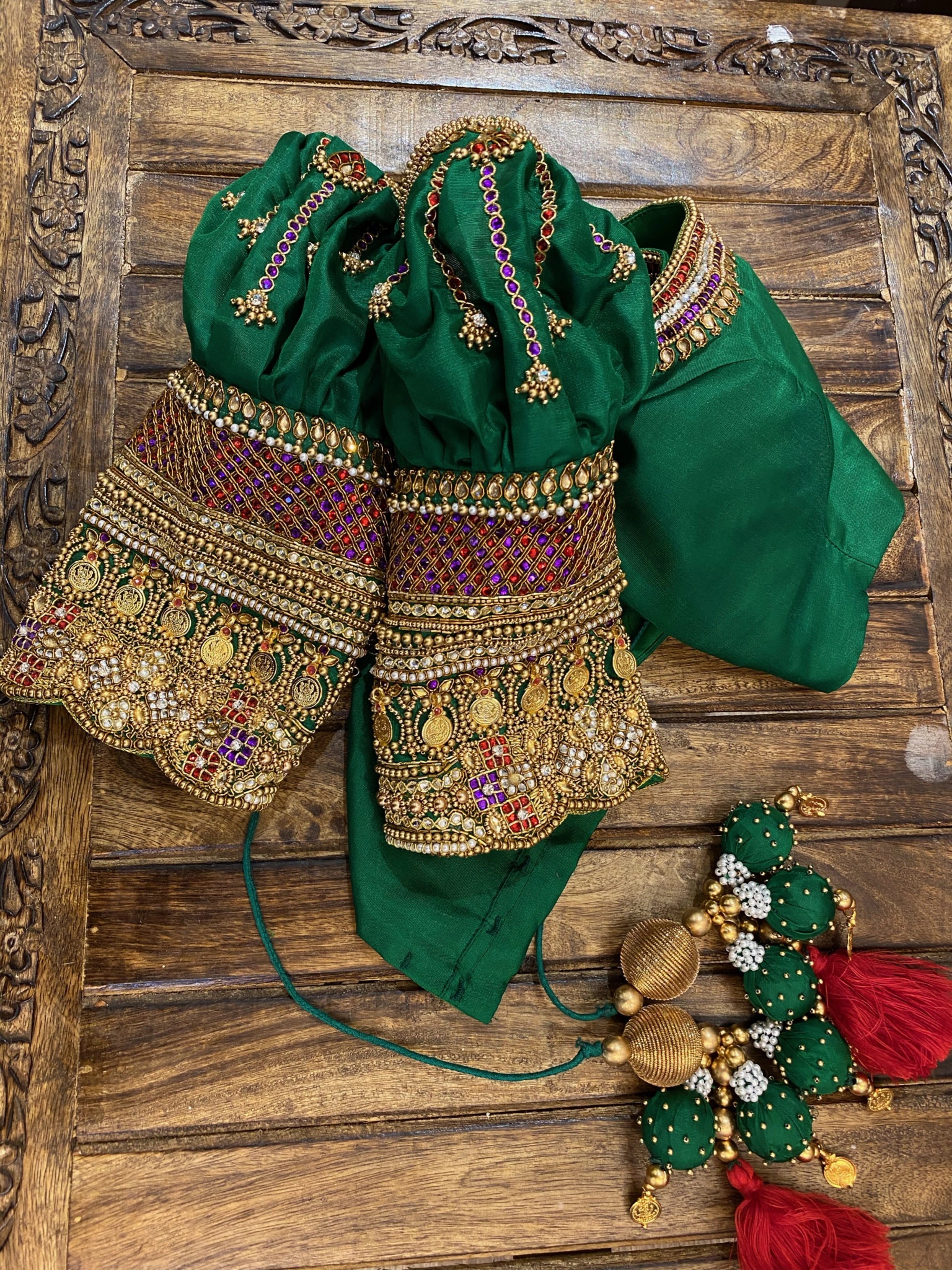 Handcrafted green silk blouse for bride Shalini from Kerala, embellished with beads, zardozi, kundan, kemp stones, coins &amp; pearls by team Archana Karthick.