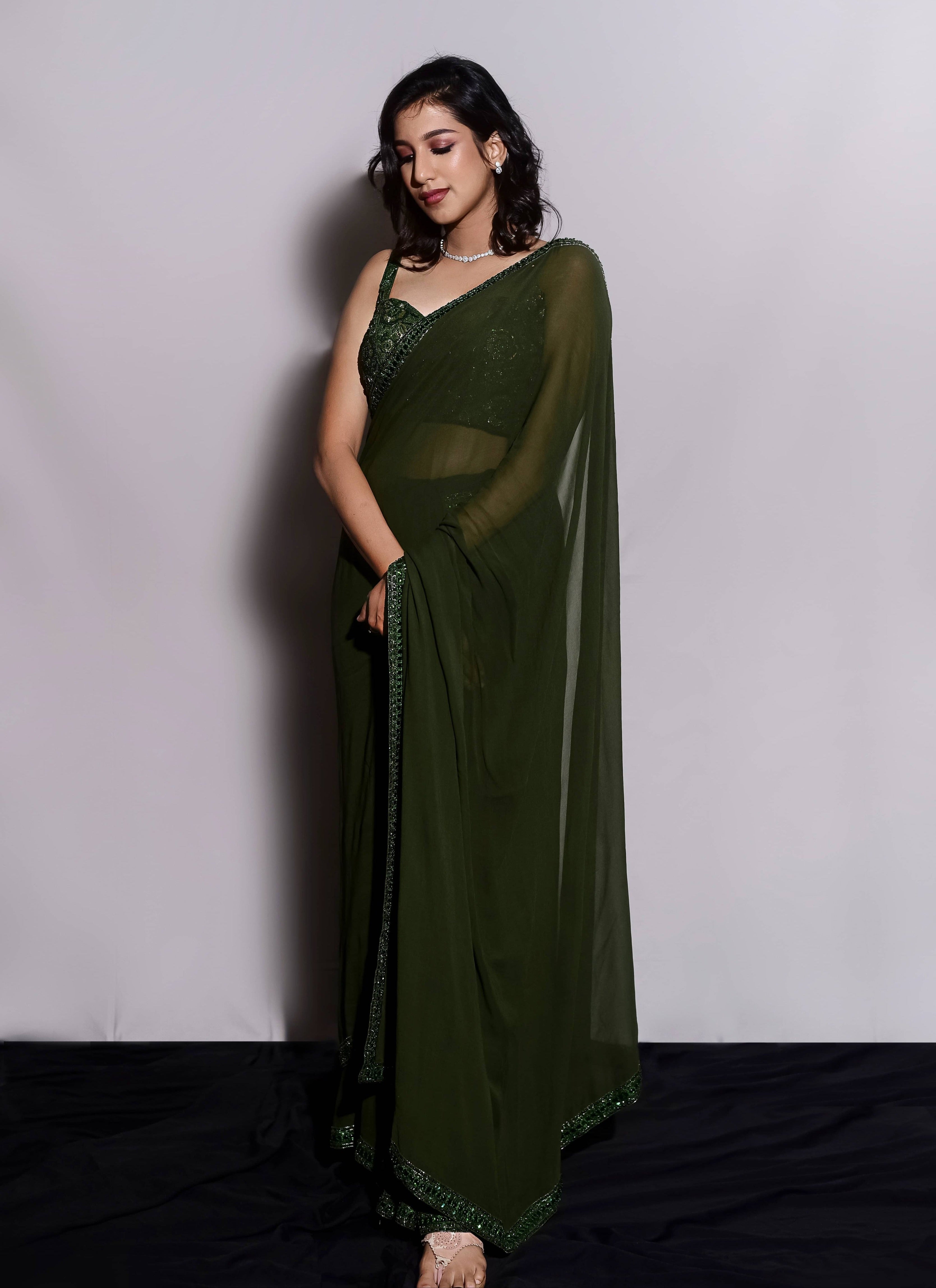 Influencer & Model Ashwini Kumar in a moss Green georgette saree paired with a heavily embellished bralette from the Lo-Mance Collection by Archana Karthick.