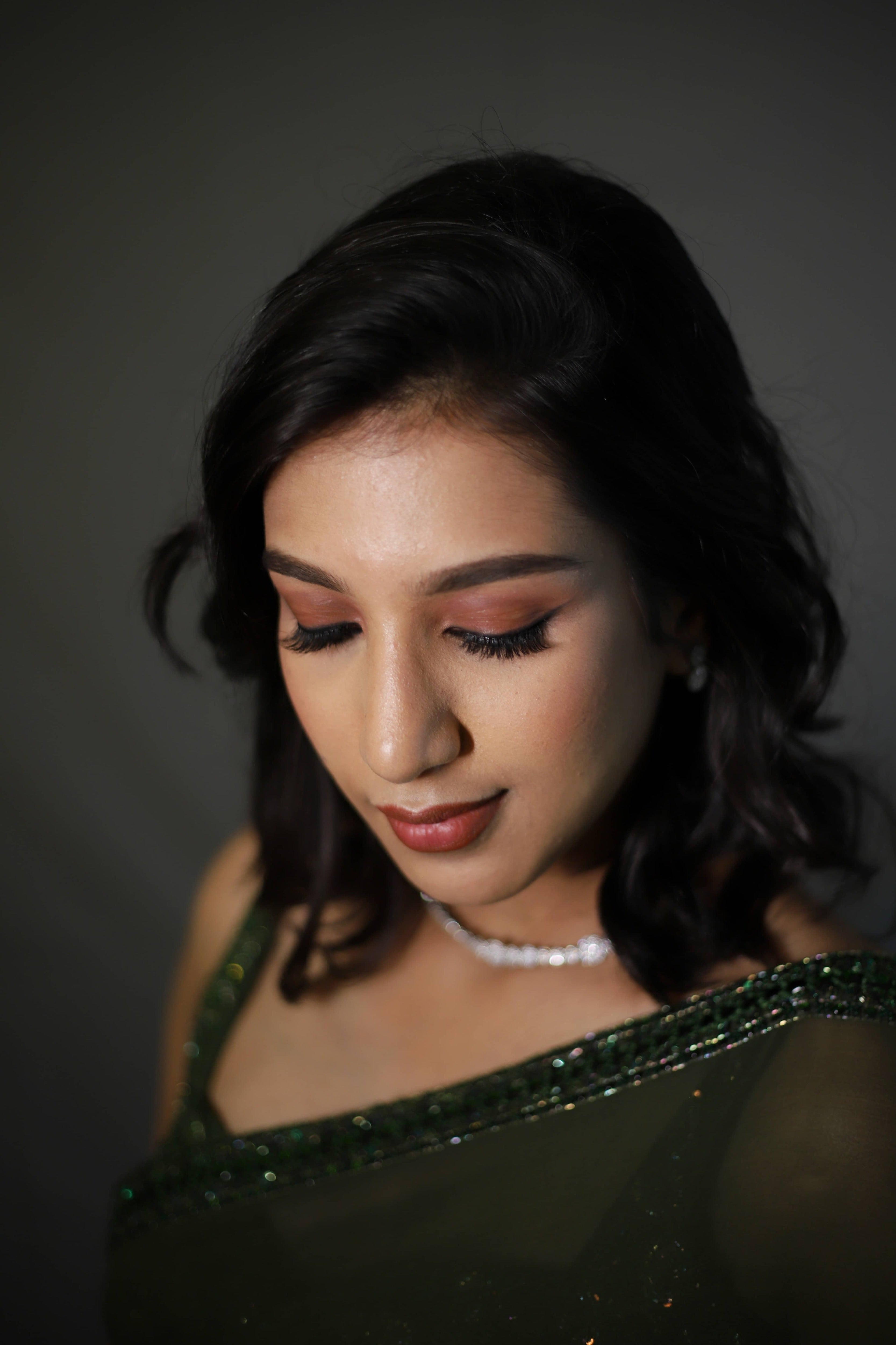 Influencer & Model Ashwini Kumar during a photoshoot in a moss Green georgette saree paired with a heavily embellished bralette from the Lo-Mance Collection by Archana Karthick.