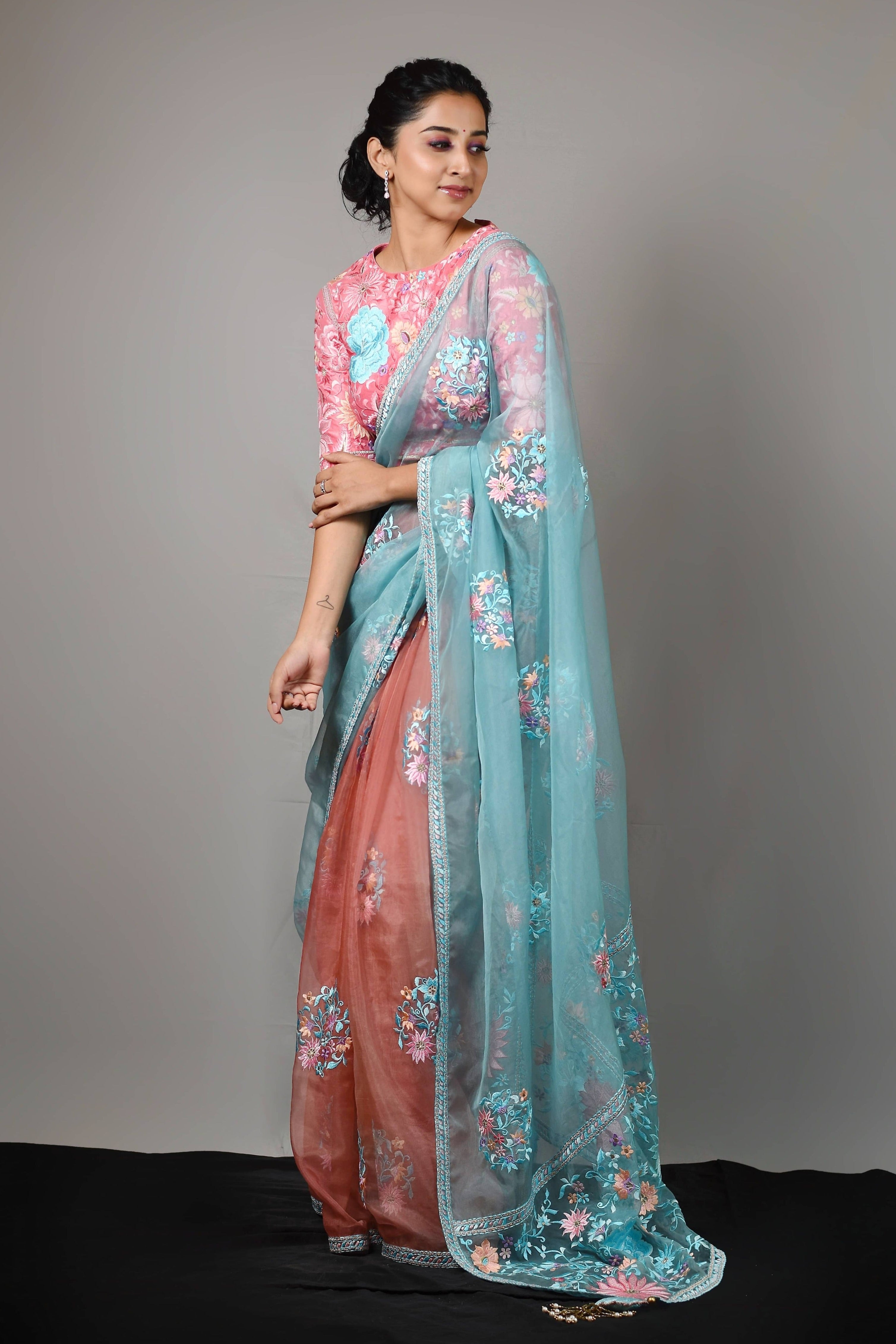 Influencer Deekshita Nikkam in powder pink and powder blue organza saree set designed by Archana Karthick. Smiling pose.