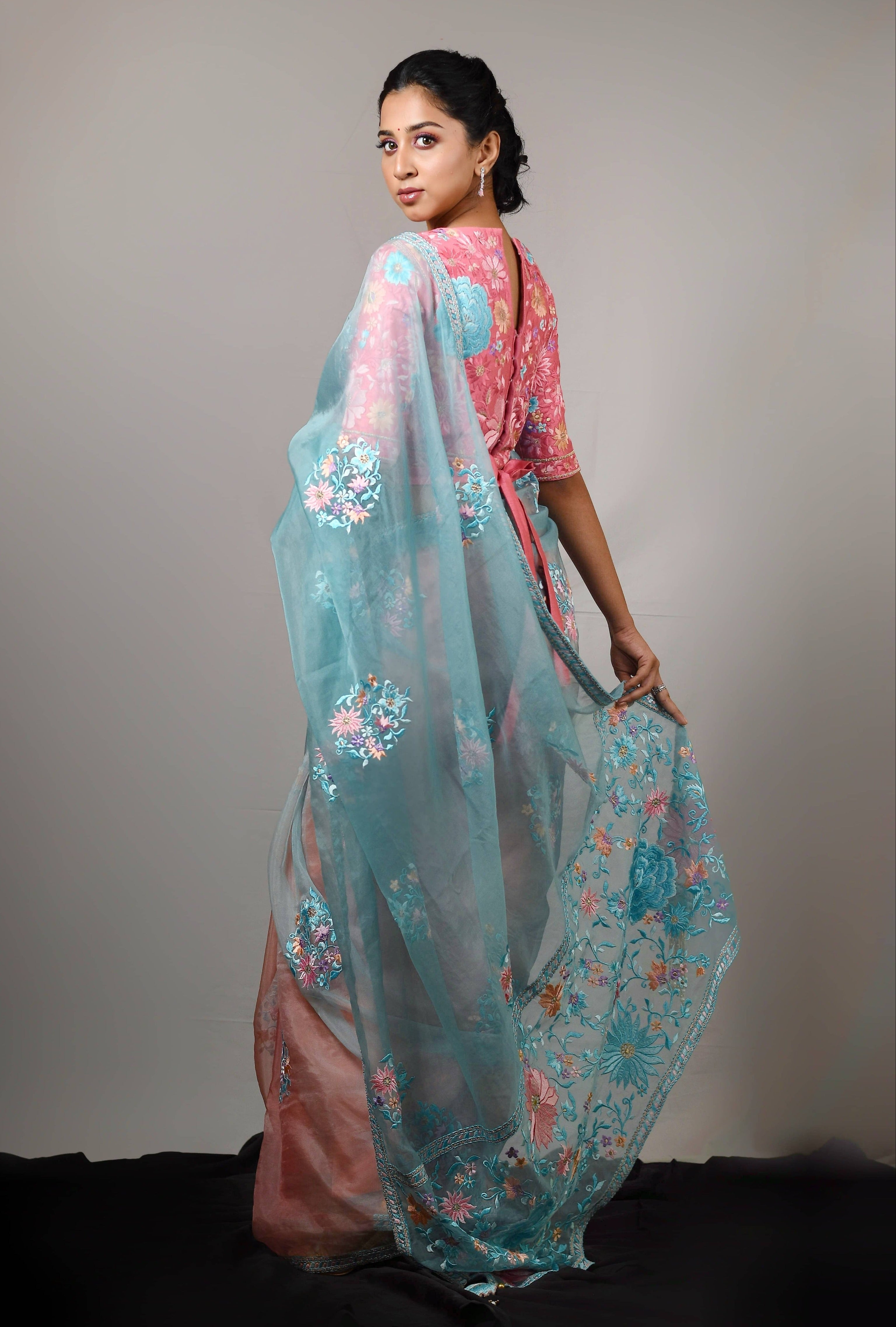 Influencer Deekshita Nikkam in powder pink and powder blue organza saree set designed by Archana Karthick. Wait tie up blouse. Back blouse and saree design details.