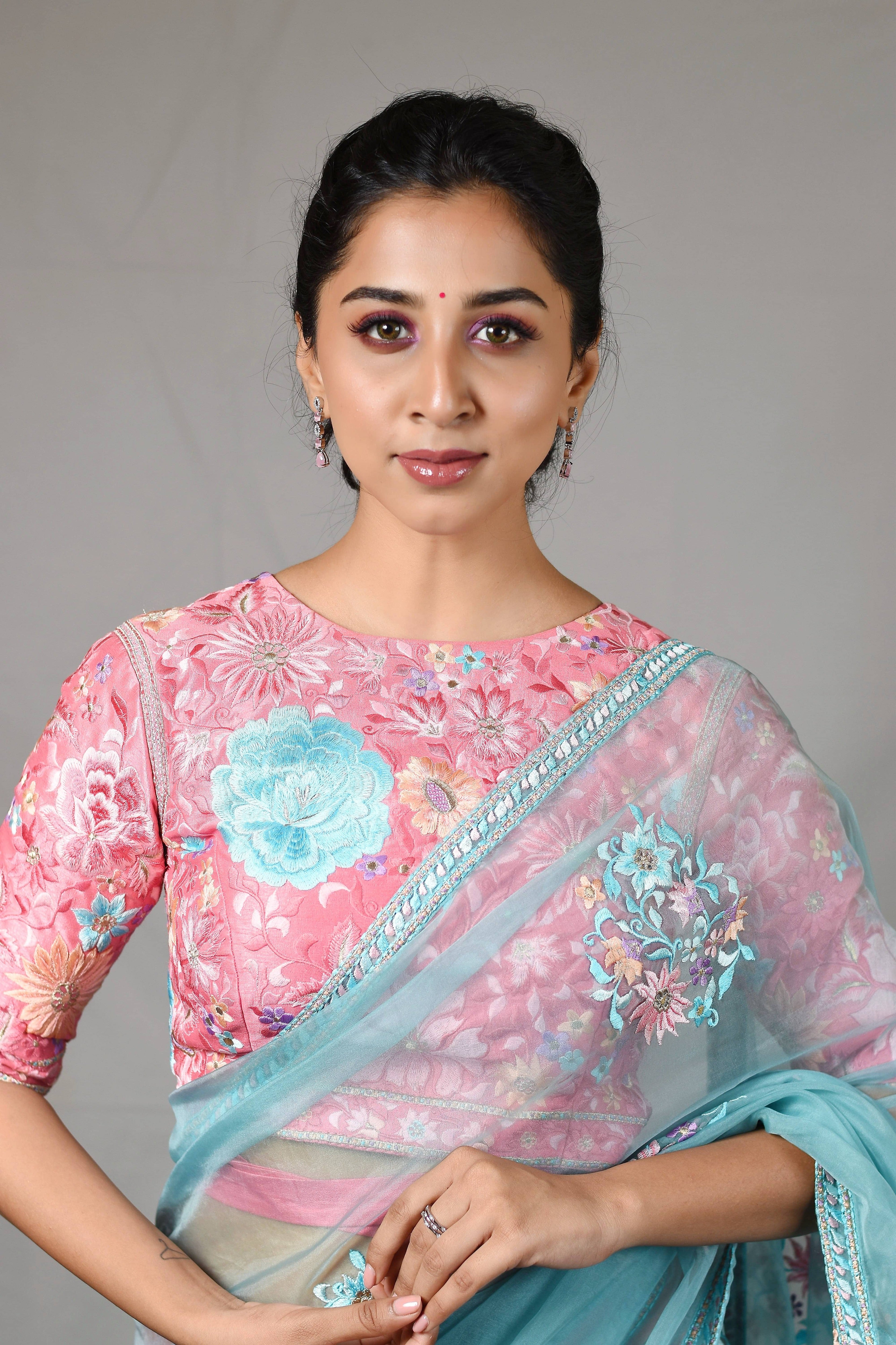 Influencer Deekshita Nikkam in powder pink and powder blue organza saree set designed by Archana Karthick. Wait tie up blouse front detailing.