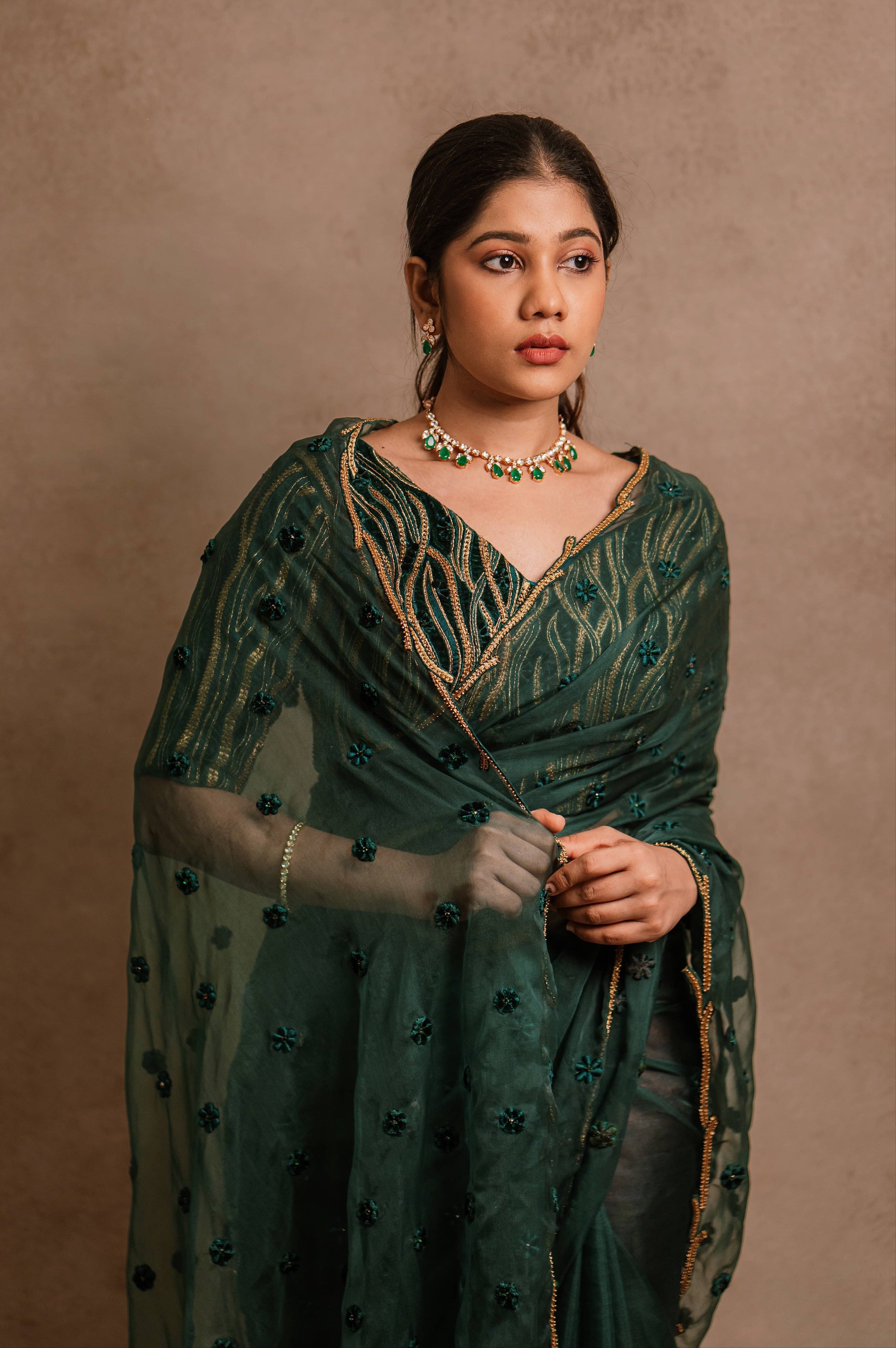 Jaina Parmar, known for recreating looks of actress Nayanthara is seen here in green organza saree set designed by Archana Karthick and is looking away from camera
