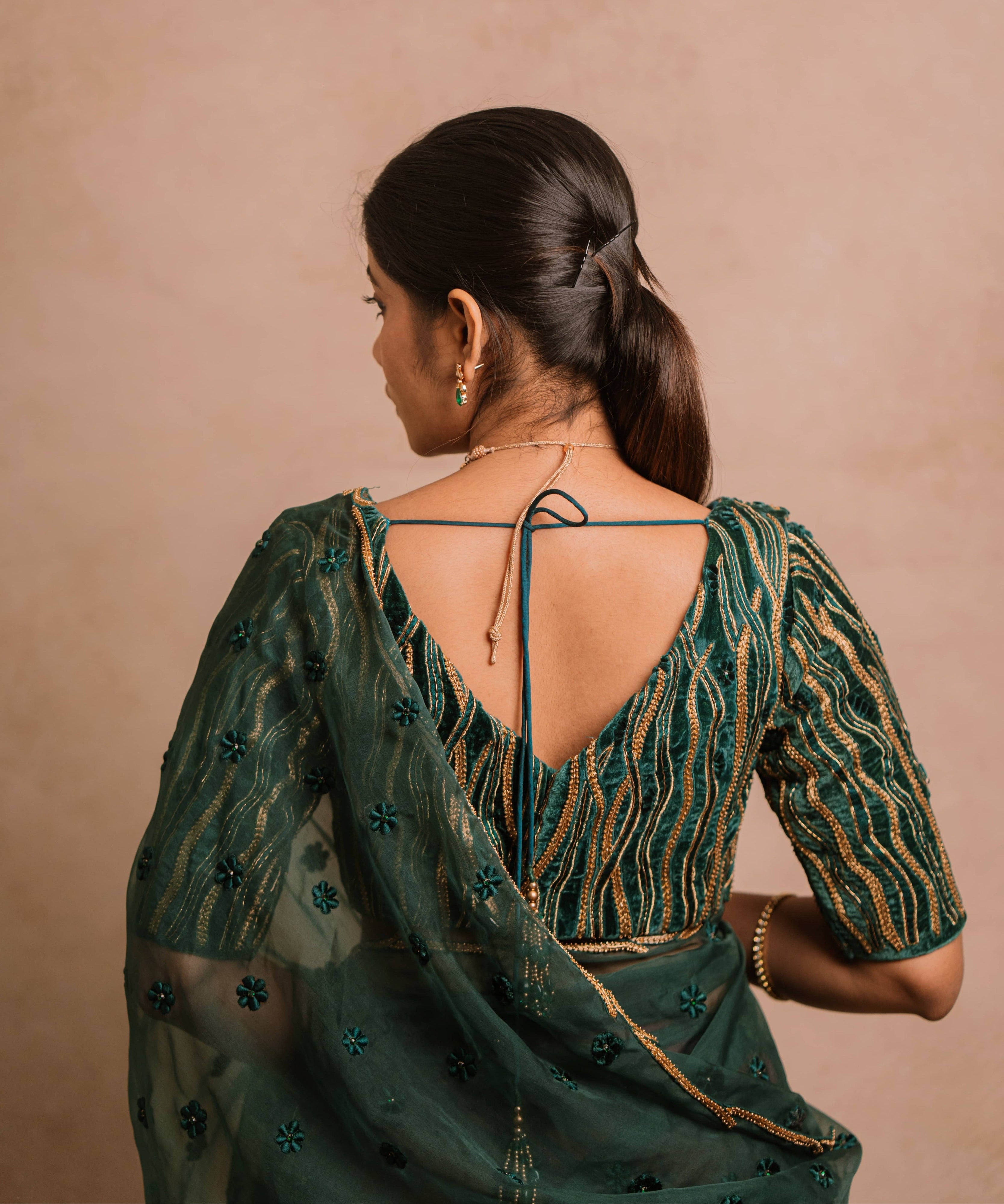 Jaina Parmar, known for recreating looks of actress Nayanthara is seen here in green organza saree set designed by Archana Karthick posing for back blouse design