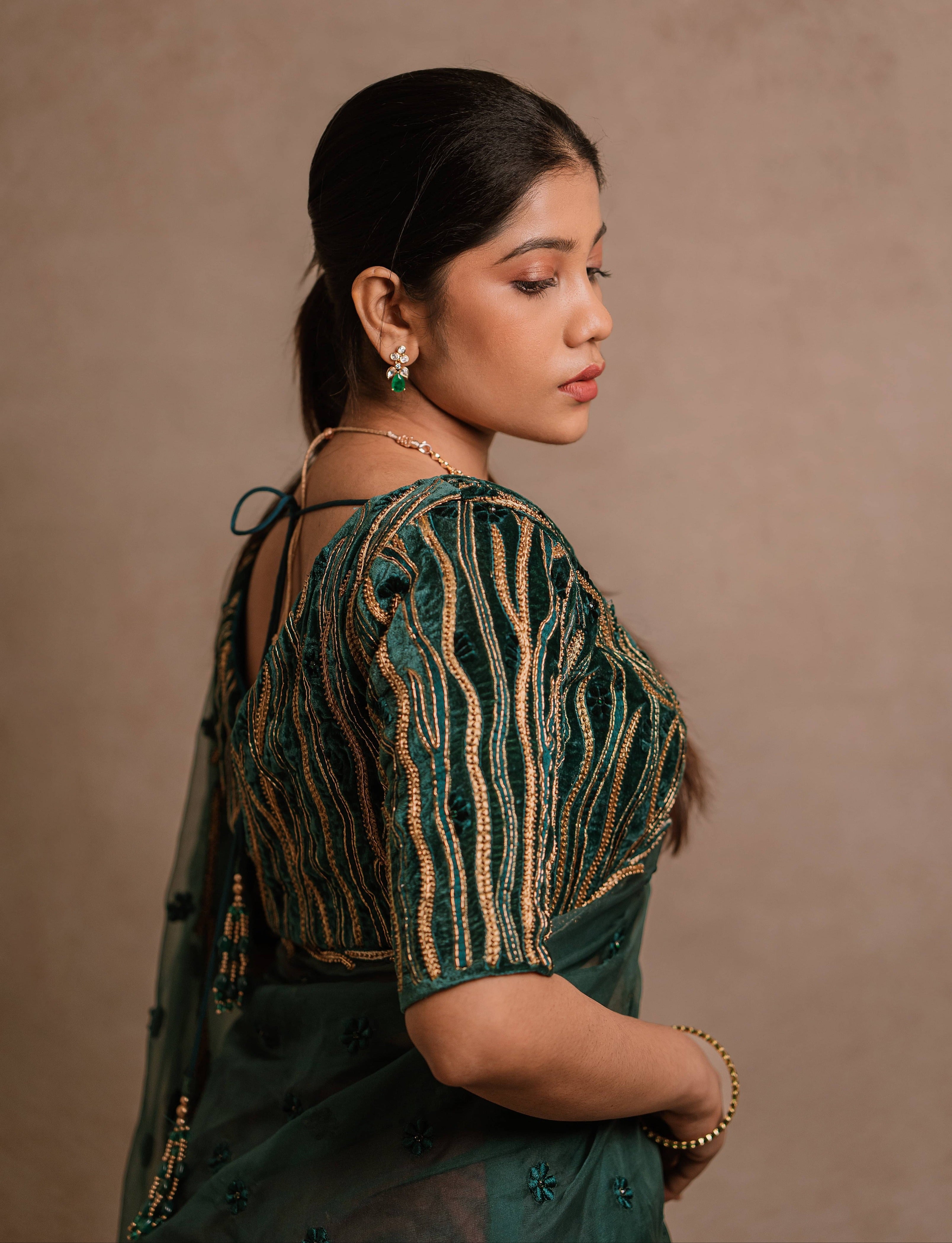 Jaina Parmar, known for recreating looks of actress Nayanthara is seen here in green organza saree set designed by Archana Karthick posing for blouse sleeve design