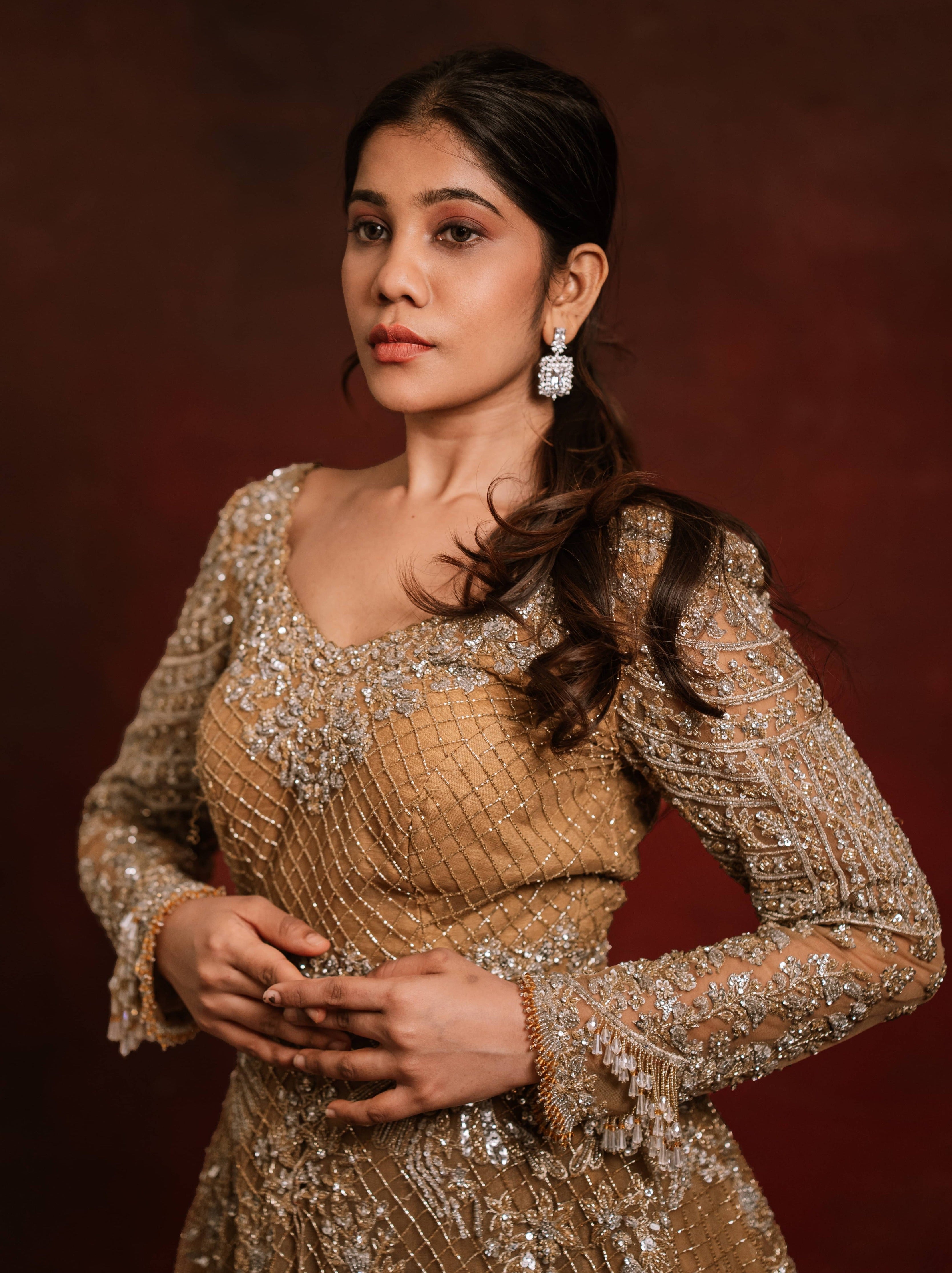 Jaina Parmar, who is known for recreating looks of actress Nayanthara is seen here in a mustard peplum sharara designed by Archana Karthick posing for a closeup