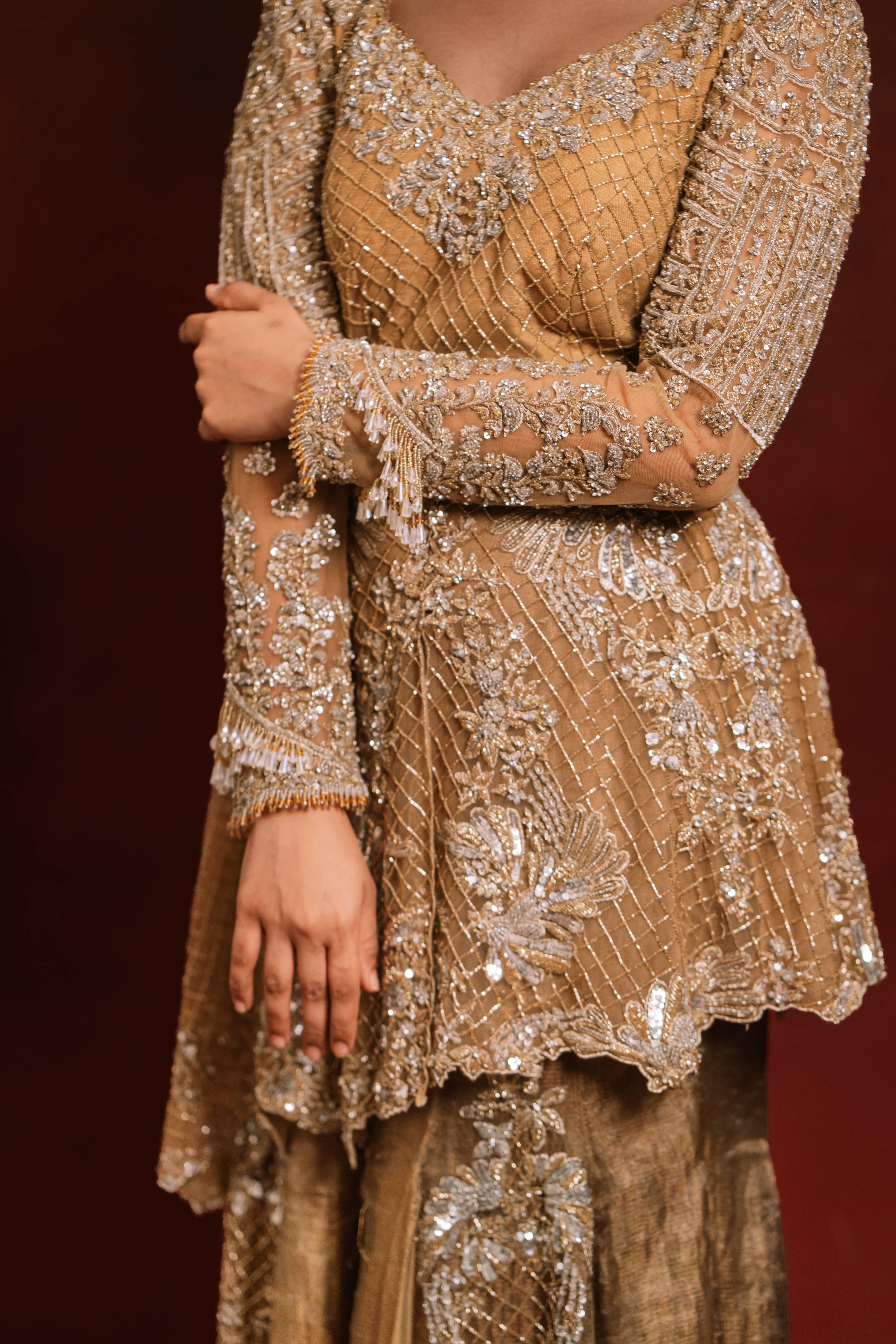 Jaina Parmar, who is known for recreating looks of actress Nayanthara is seen here in a mustard peplum sharara designed by Archana Karthick posing for a closeup of the design details