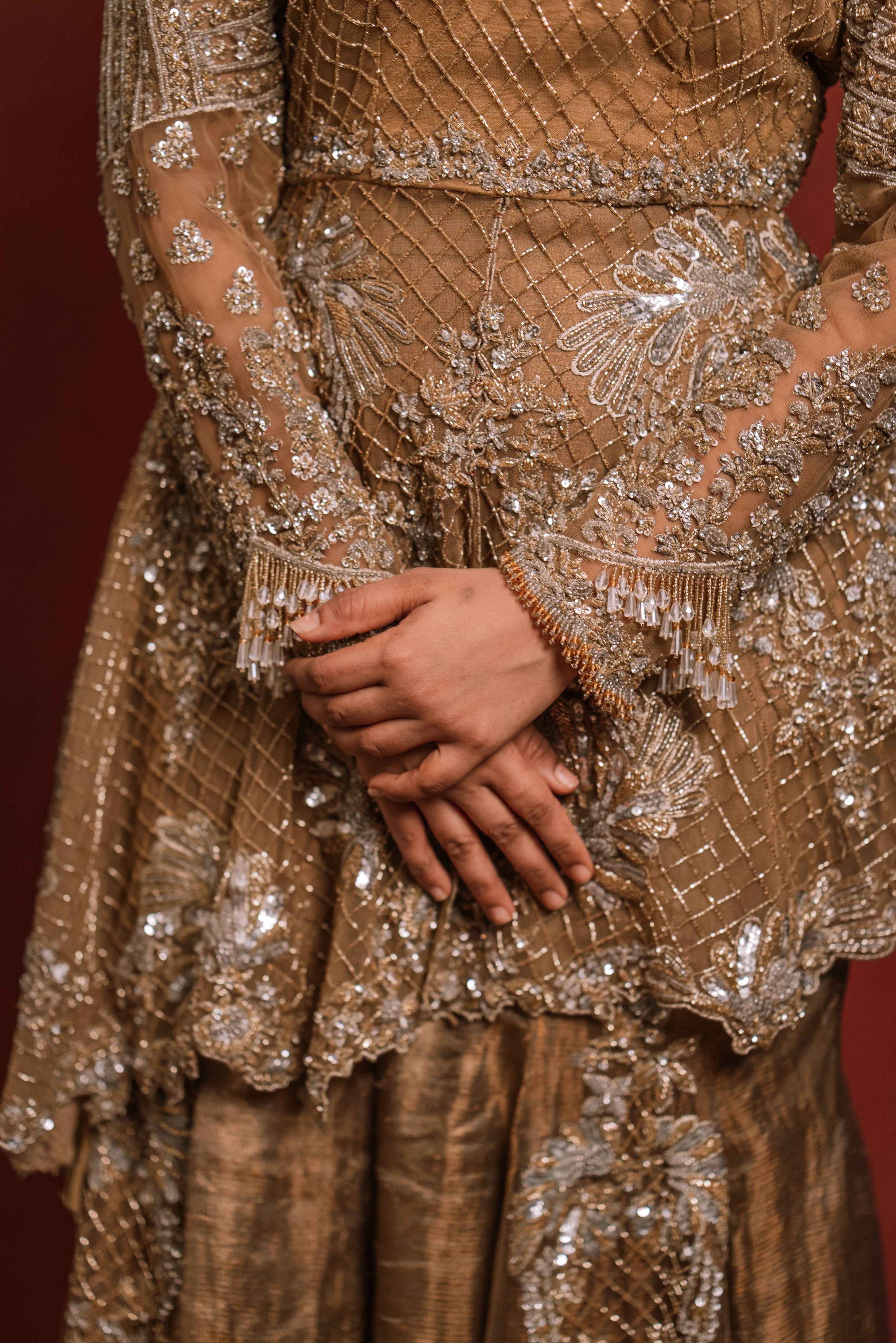 Jaina Parmar, who is known for recreating looks of actress Nayanthara is seen here in a mustard peplum sharara designed by Archana Karthick posing for a closeup of the peplum design details