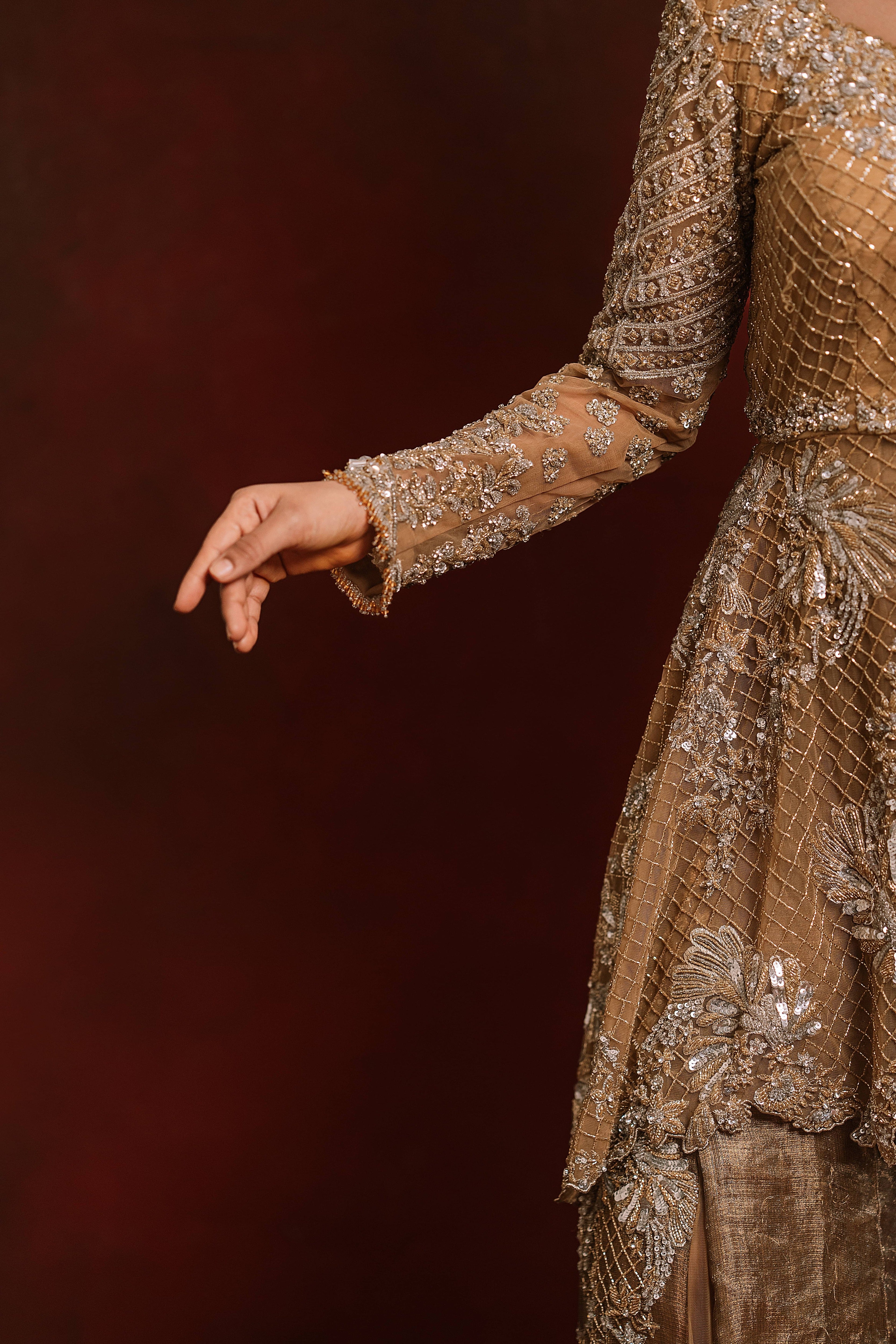 Jaina Parmar, who is known for recreating looks of actress Nayanthara is seen here in a mustard peplum sharara designed by Archana Karthick posing for a closeup of the sleeve and peplum design details