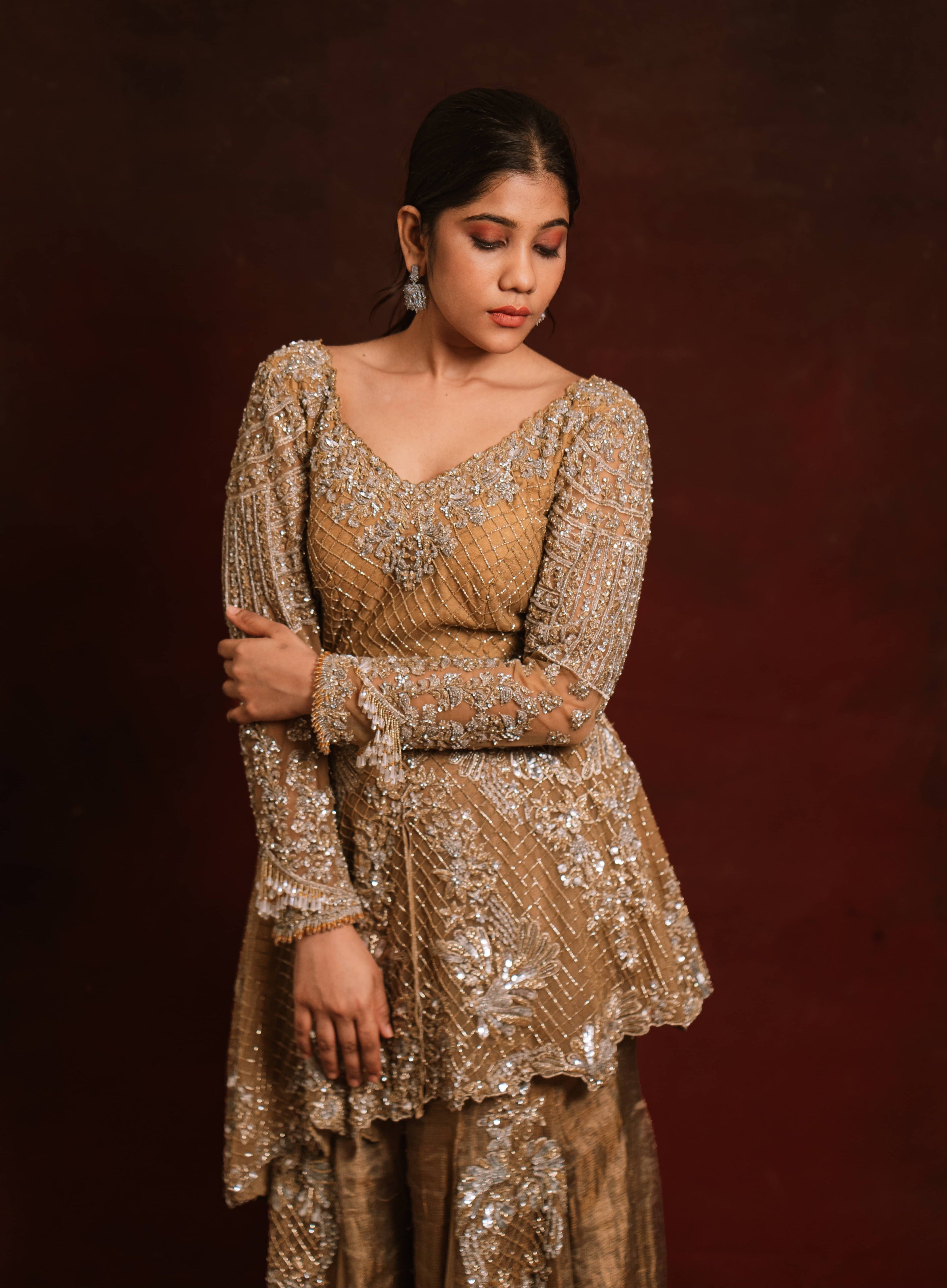 Jaina Parmar, who is known for recreating looks of actress Nayanthara is seen here in a mustard peplum sharara designed by Archana Karthick posing for a shoot