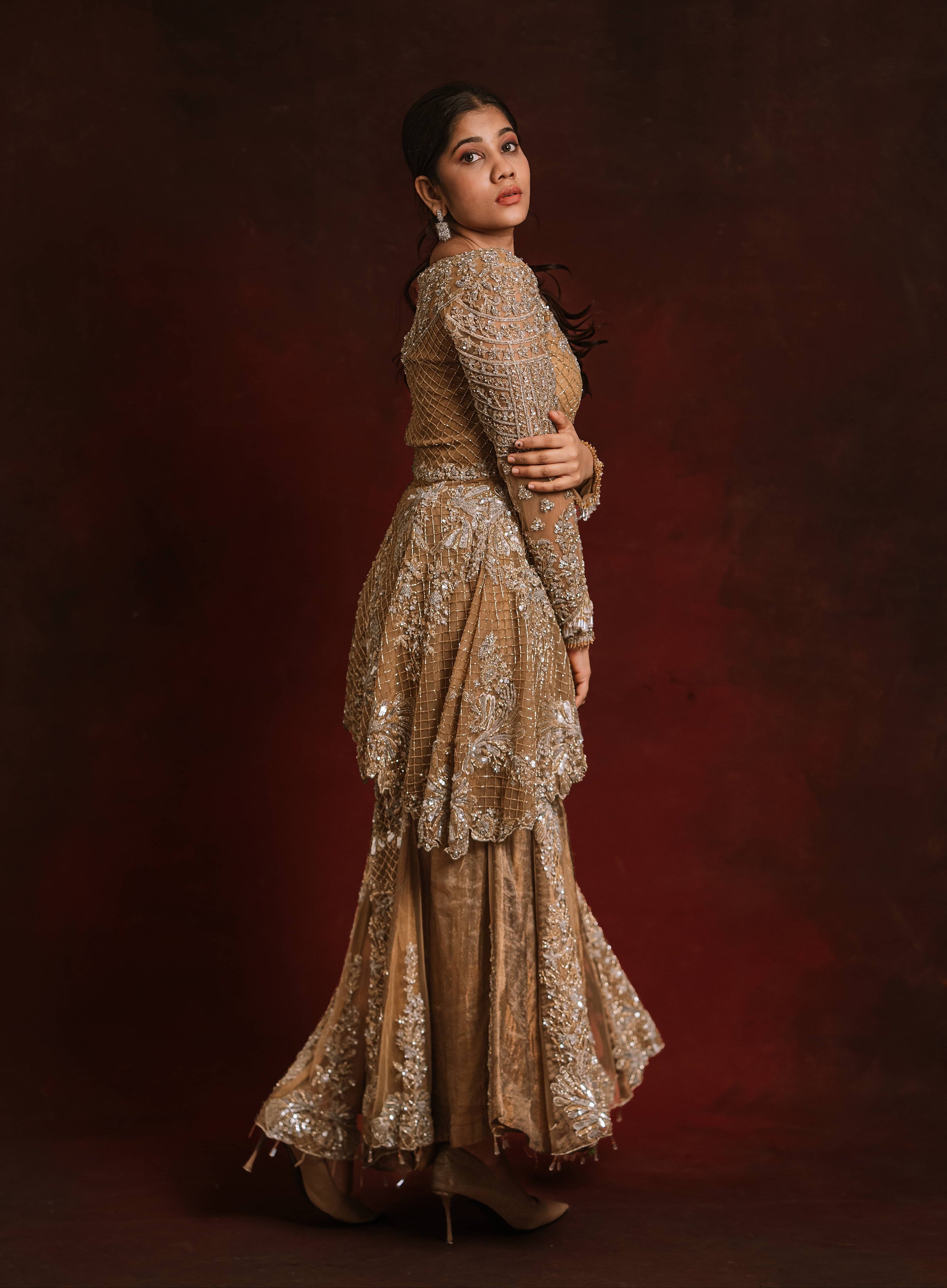 Jaina Parmar, who is known for recreating looks of actress Nayanthara is seen here in a mustard peplum sharara designed by Archana Karthick posing for a side profile shoot