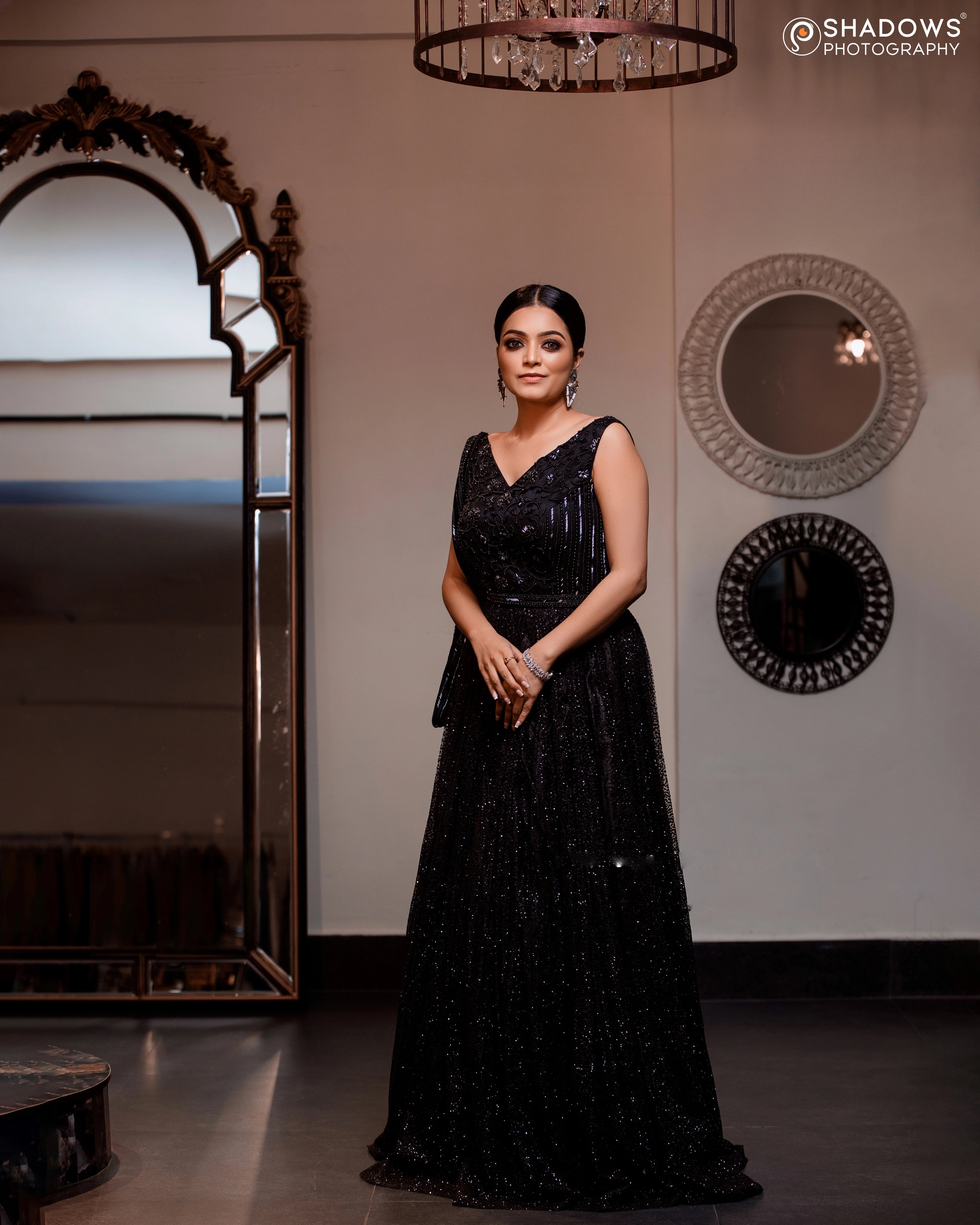 Janani Iyer in a black net and satin gown with handcrafted drape, intricately designed with cutdana, sequins and beads by team Archana Karthick.