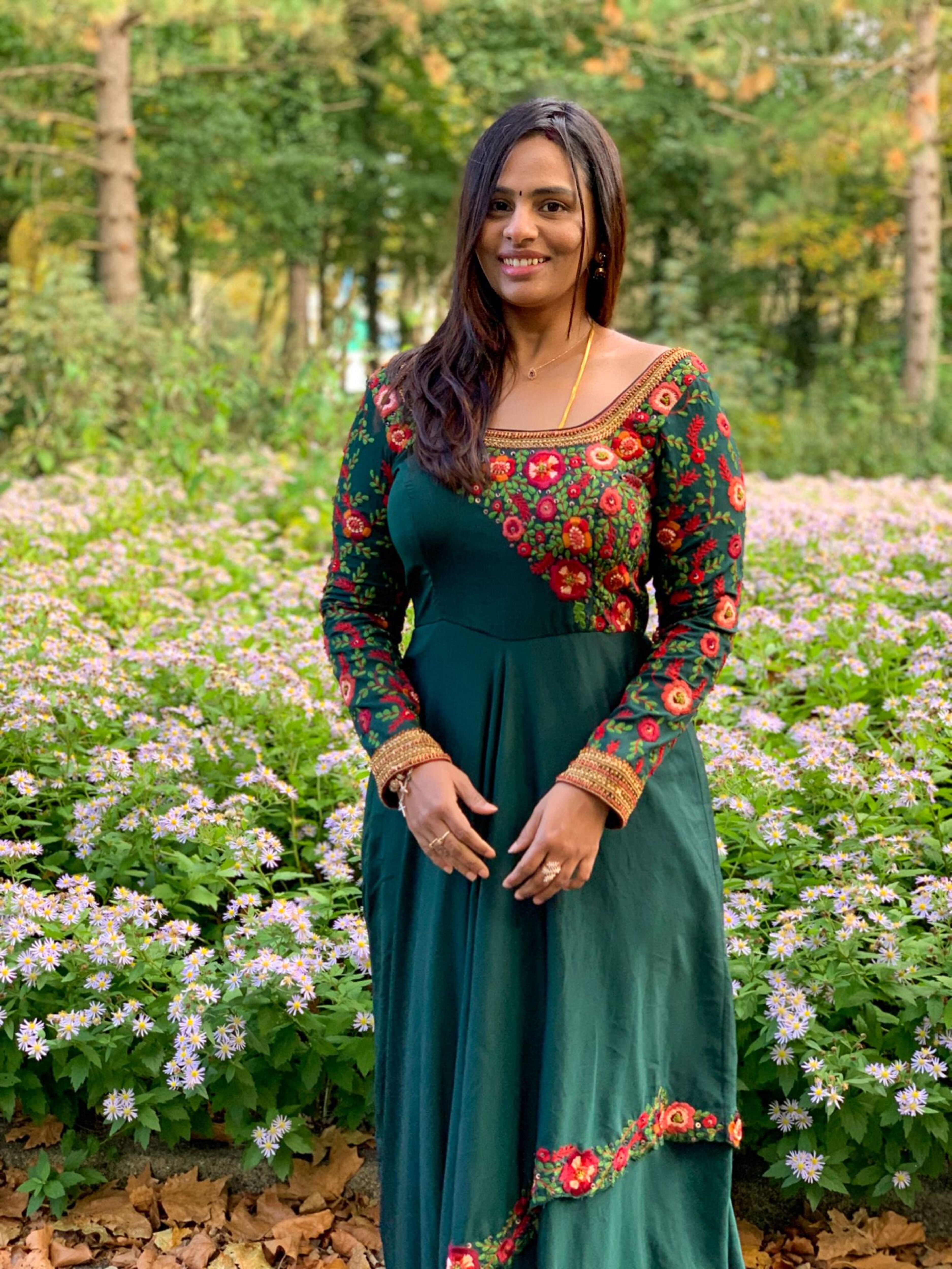 Kowsalya fro Buffalo, USA in an a green multi-layered anarkali designed by Archana Karthick. Straight at the camera.