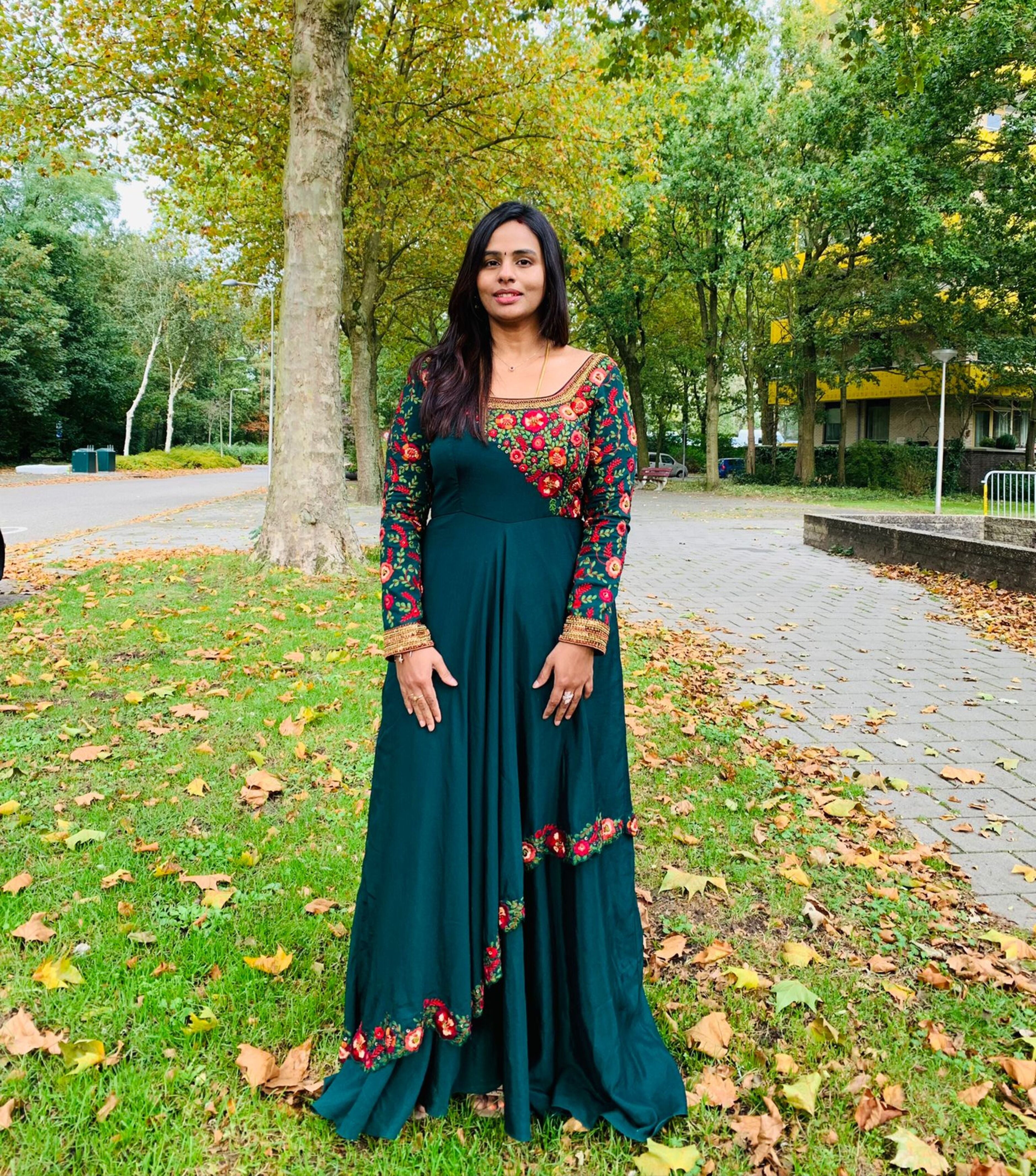 Kowsalya fro Buffalo, USA in an a green multi-layered anarkali designed by Archana Karthick. Straight at the camera full profile.