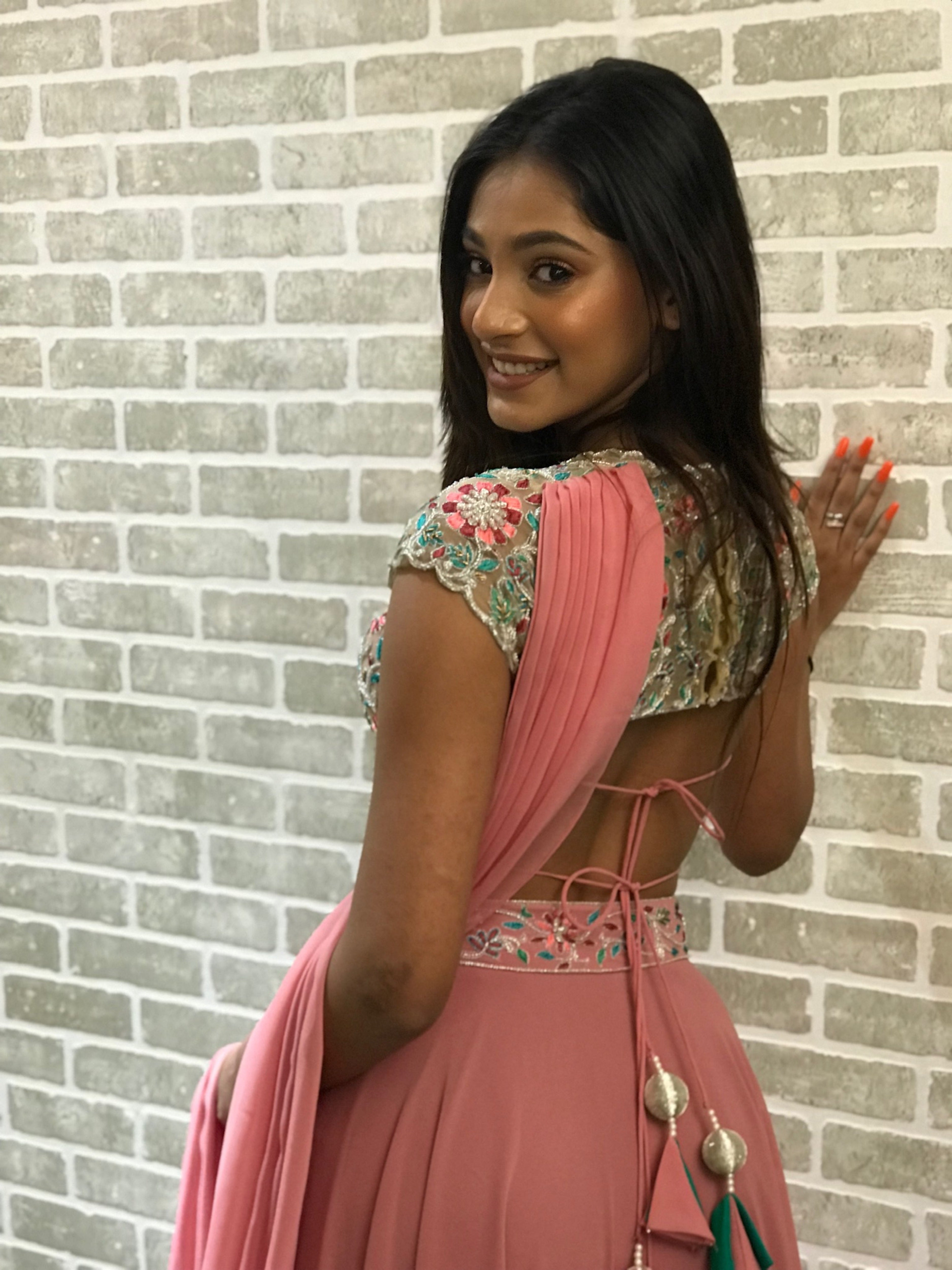 Miss India 2018 and actress Anukreethy Vas in a powder pink georgette sharara with palazzo pants. Blouse back design and attached dupatta