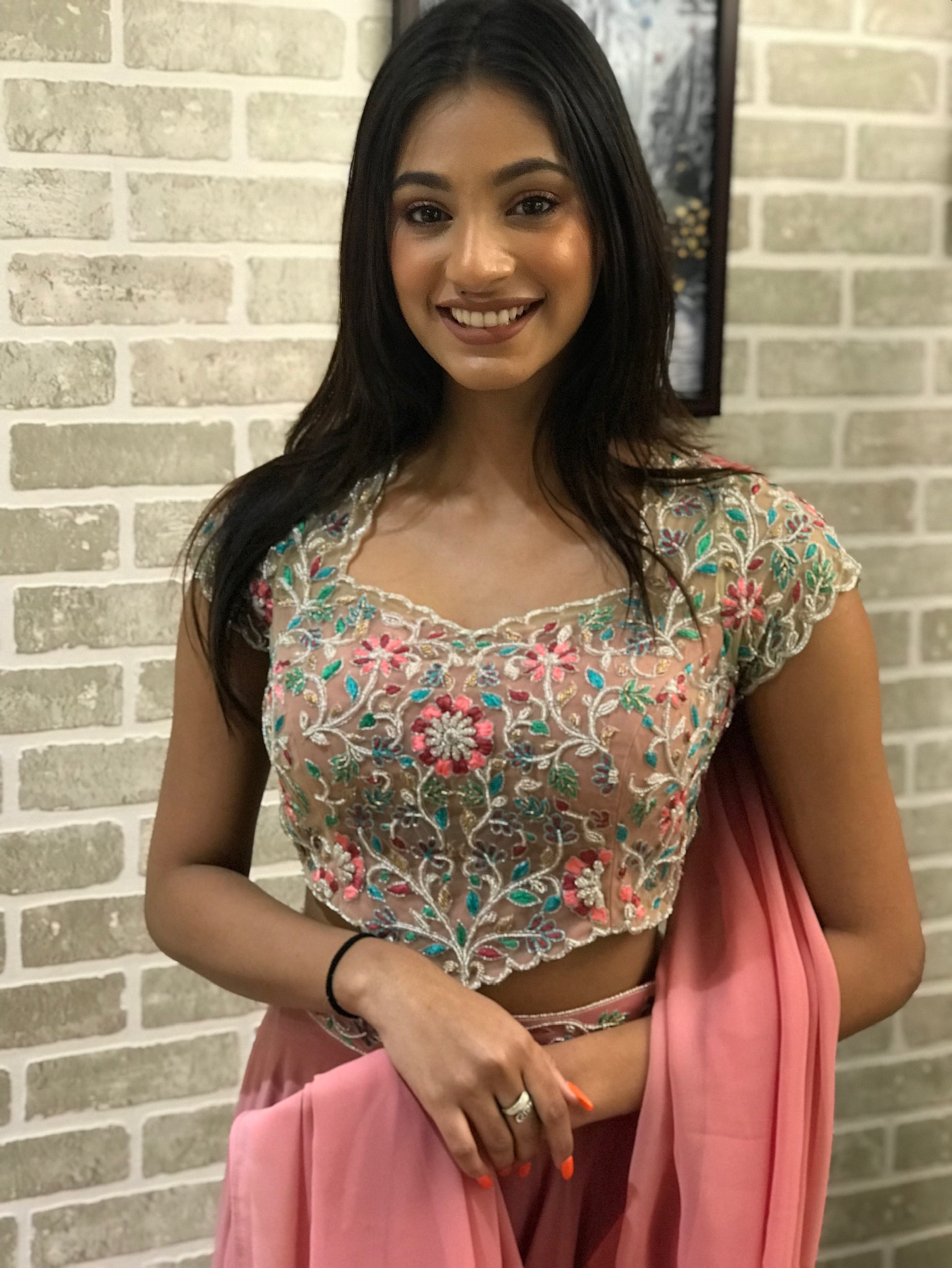 Miss India 2018 and actress Anukreethy Vas in a powder pink georgette sharara with palazzo pants. Posing straight at camera full front blouse.